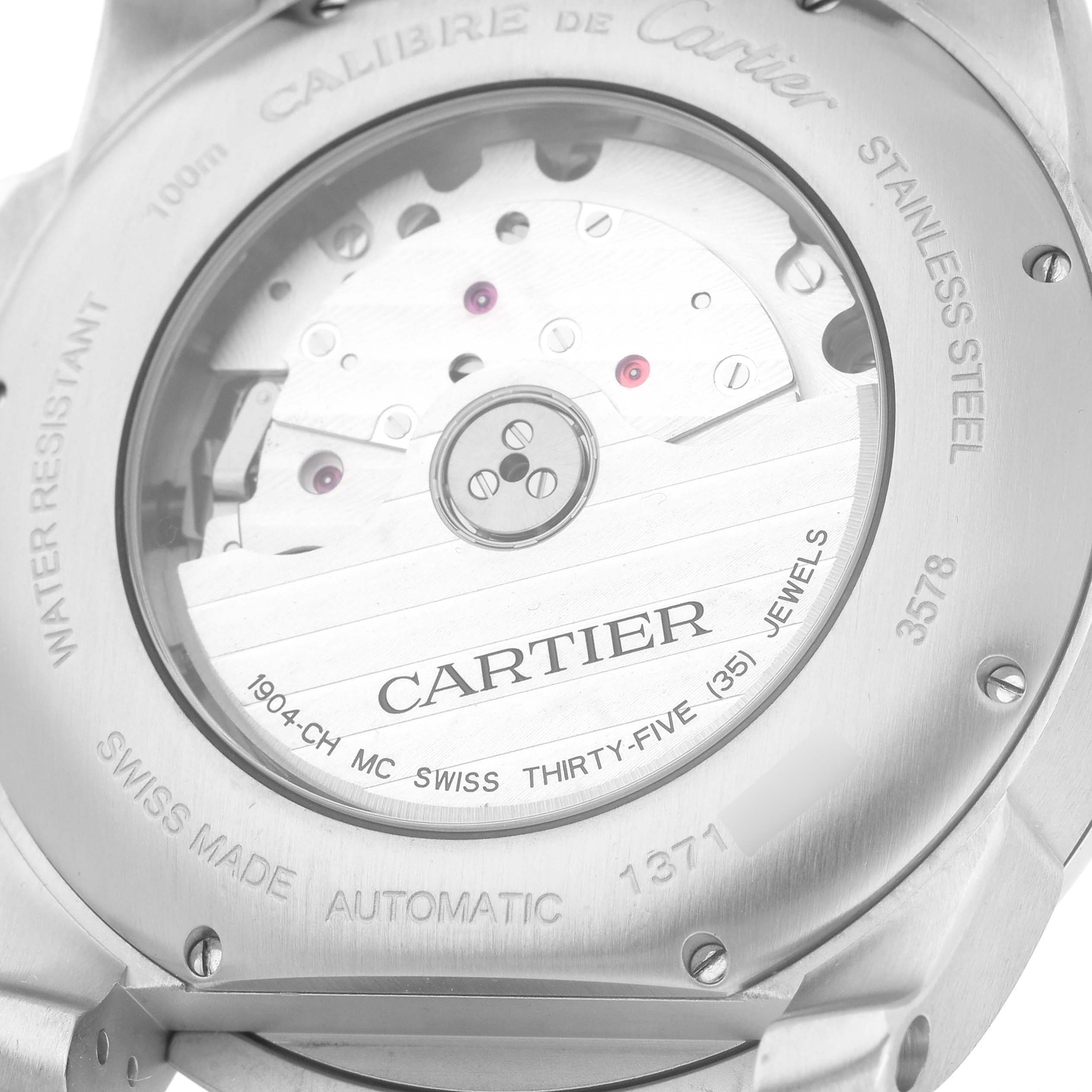 The image shows the case back of a Calibre de Cartier watch, highlighting the movement and engravings.