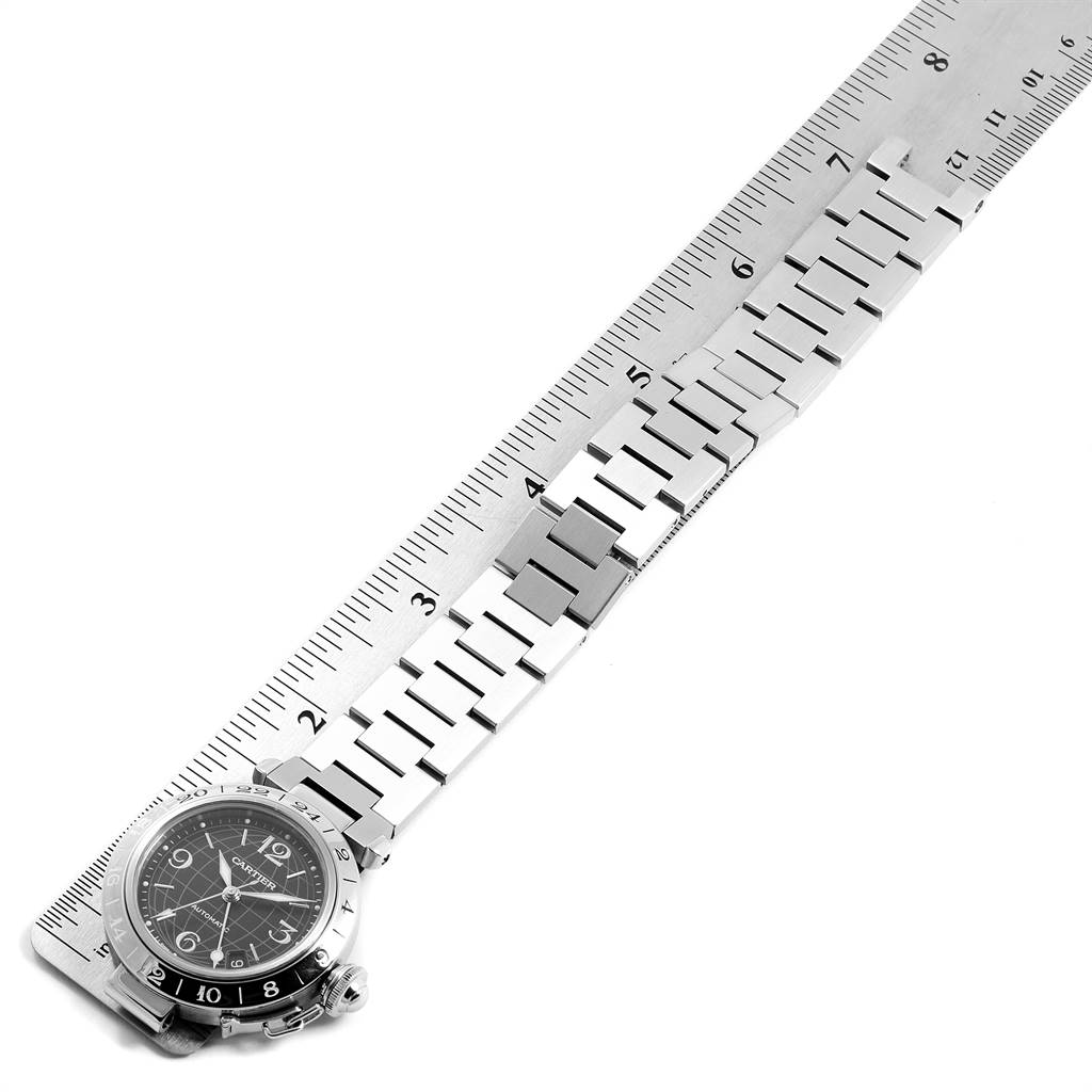 The image shows a Cartier Pasha W31049M7 Men's Stainless Steel Black Dial W31049M7 Men's Stainless Steel Black Dial model watch with a metal bracelet, laid flat beside a ruler.