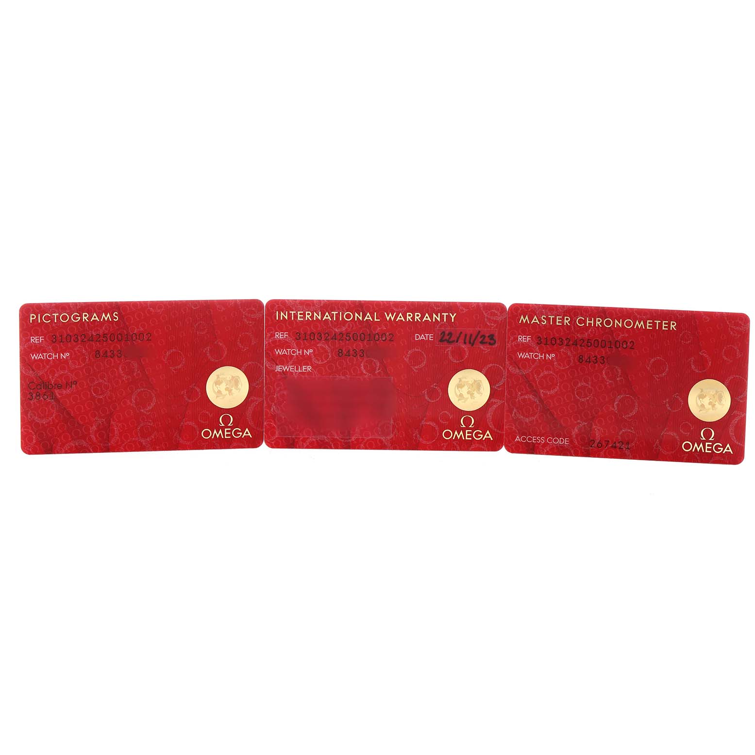 The image shows three red Omega cards at a straight angle, including Pictograms, International Warranty, and Master Chronometer cards for the Speedmaster.