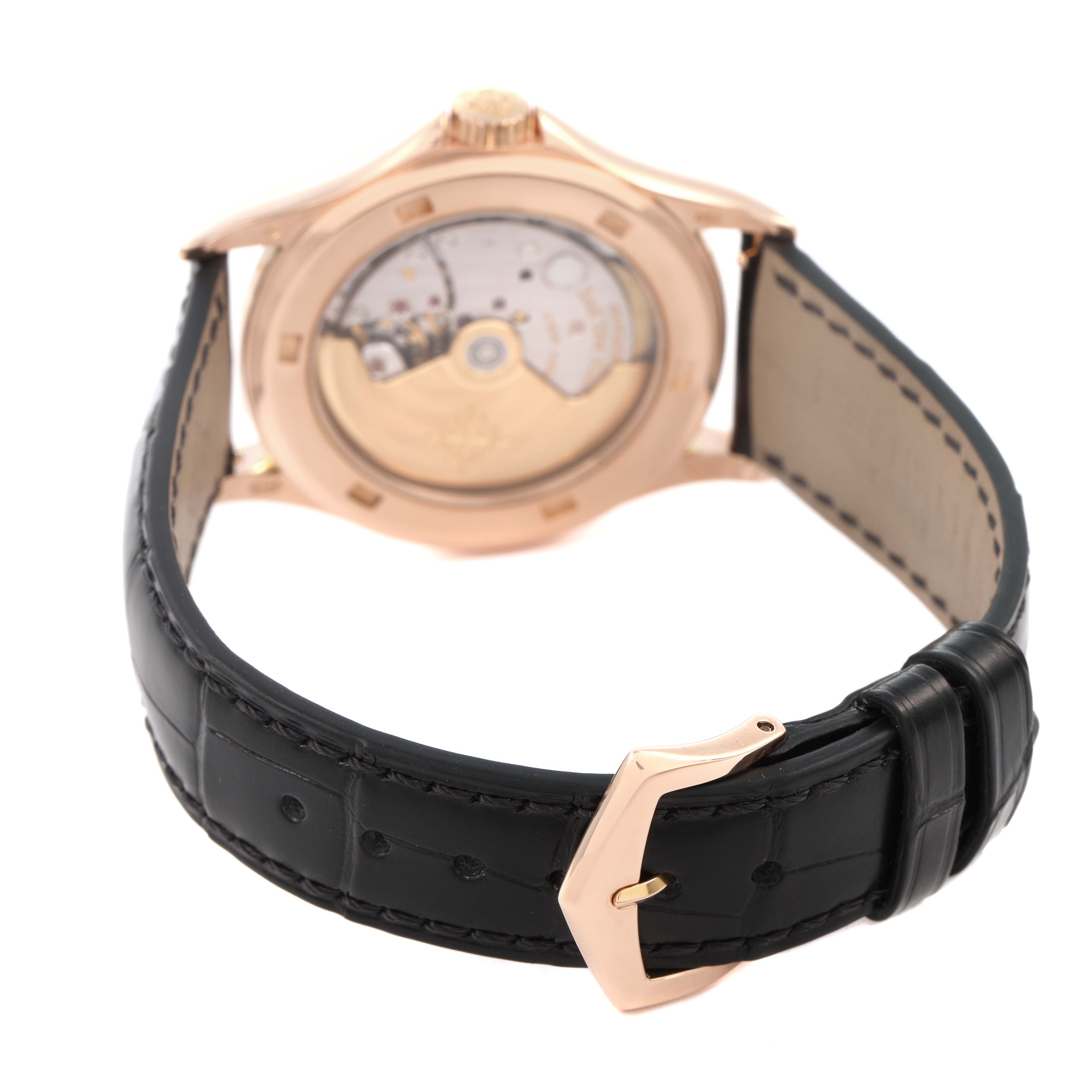 The Patek Philippe Calatrava 5117R-001 Mens Rose Gold White Dial watch is shown from the back, displaying its movement and clasp, with focus on the caseback and strap.