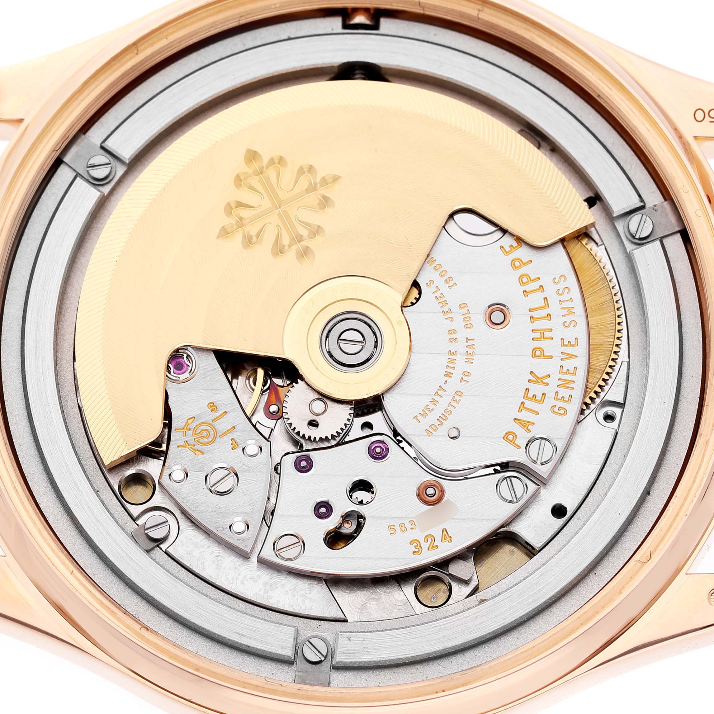 The image shows the movement of a Patek Philippe Calatrava 5296R-010 Men's Rose Gold Silver Dial watch from a close-up angled view, highlighting the intricate mechanics.