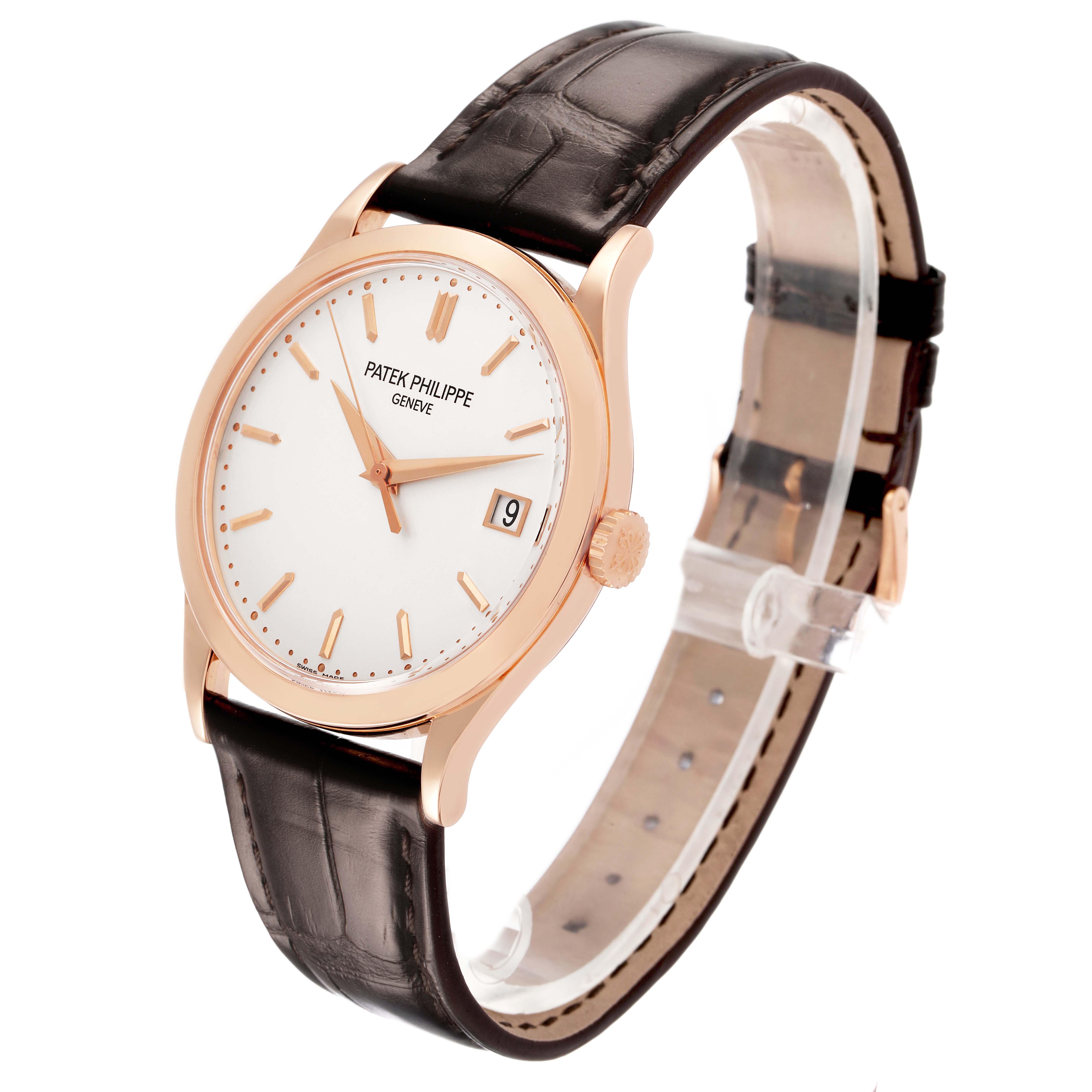The Patek Philippe Calatrava 5296R-010 Men's Rose Gold Silver Dial watch is shown at a tilted angle, displaying the face, case, crown, strap, and date window.