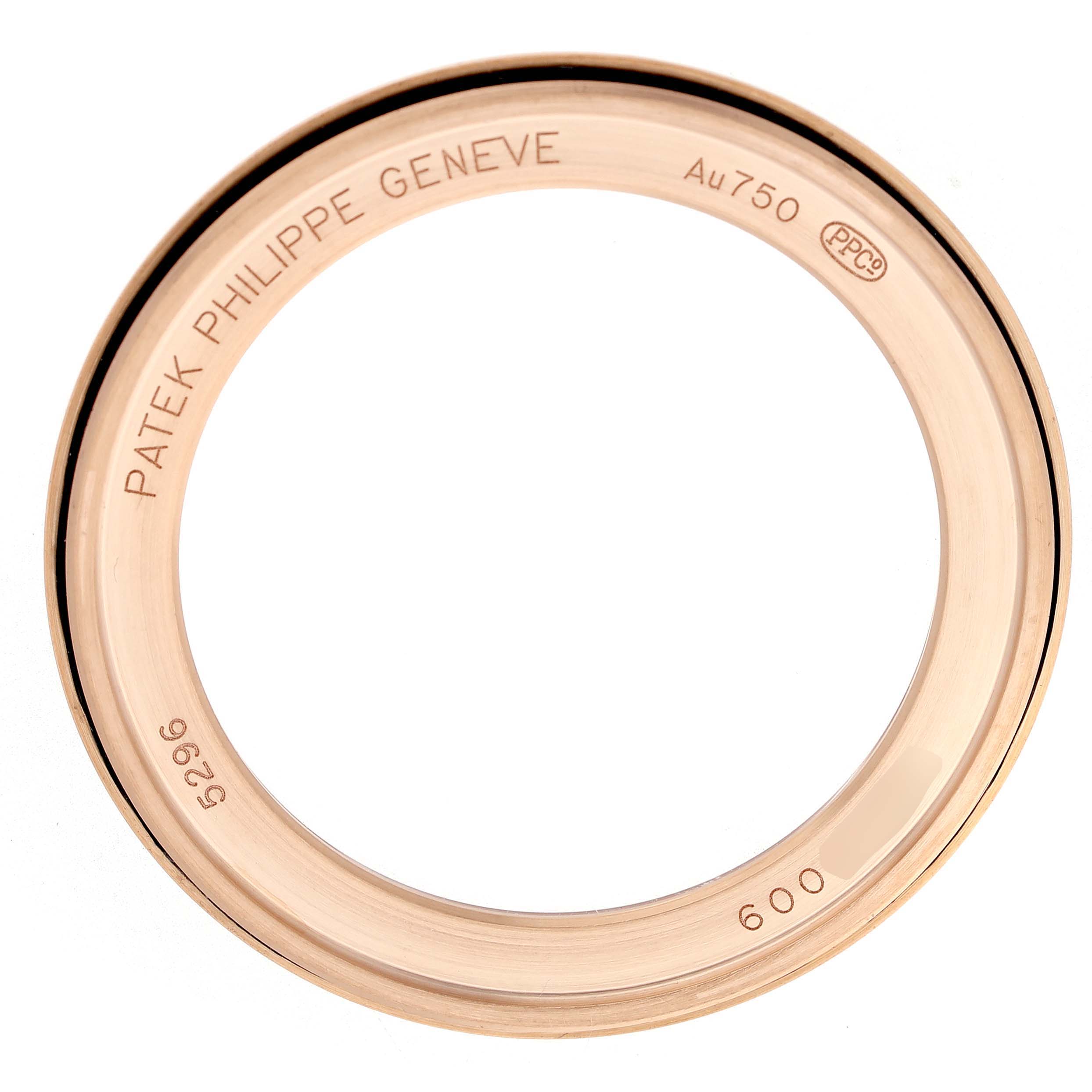 The image shows the bezel of a Patek Philippe Calatrava 5296R-010 Men's Rose Gold Silver Dial watch, displaying inscriptions and gold markings.
