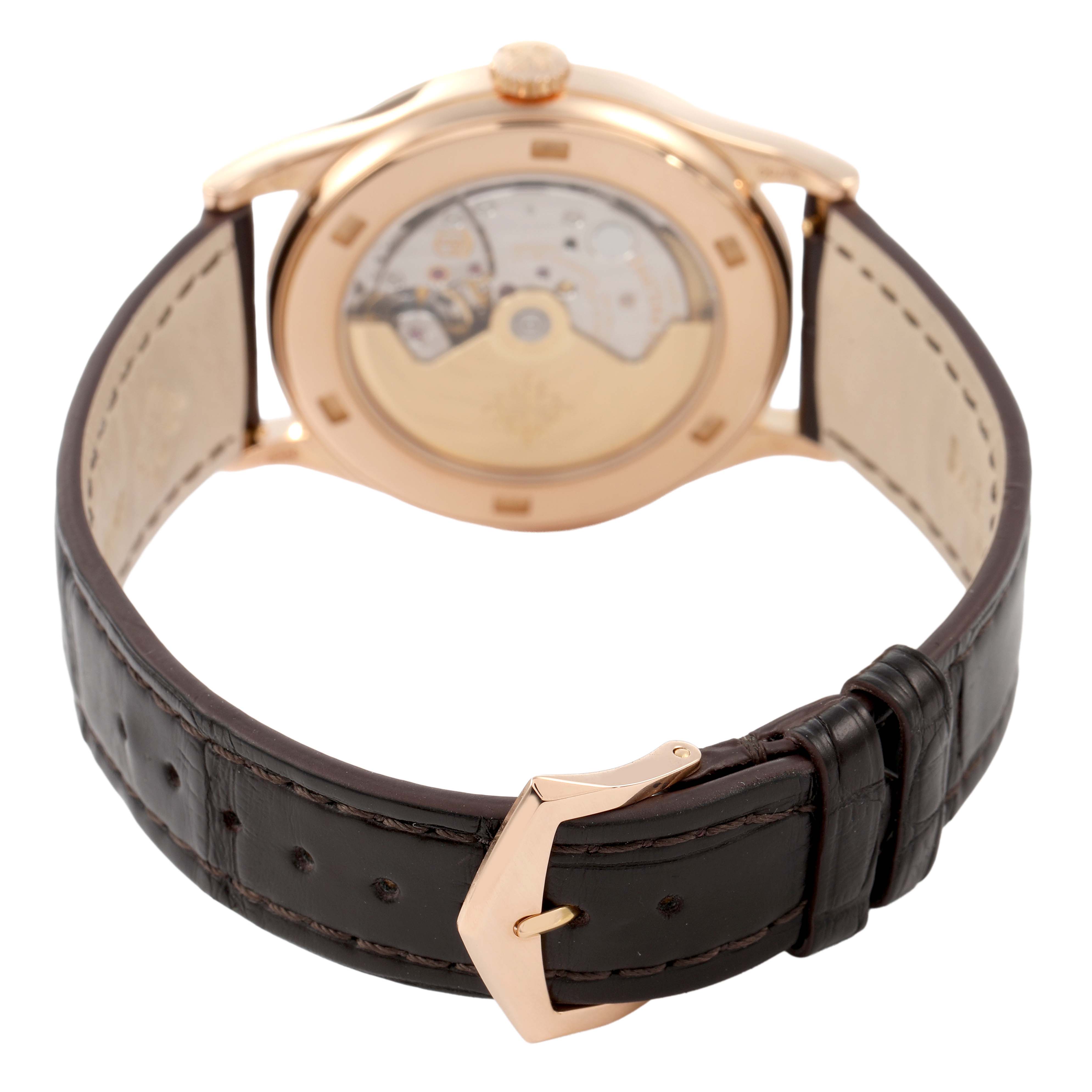 The image shows a rear view of the Patek Philippe Calatrava 5296R-010 Men's Rose Gold Silver Dial model, highlighting the transparent case back and leather strap buckle.