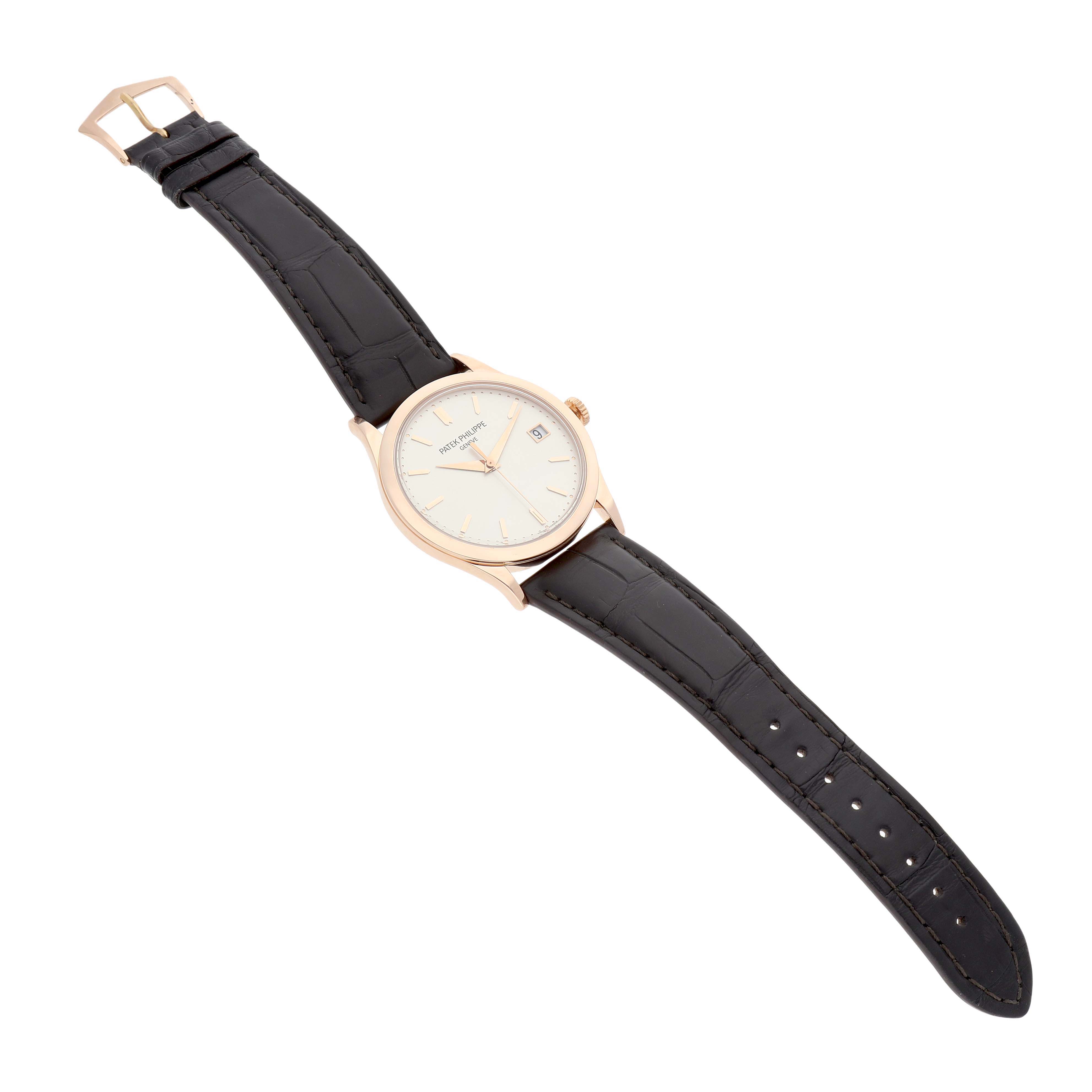 The Patek Philippe Calatrava 5296R-010 Men's Rose Gold Silver Dial watch is shown at a slight angle, displaying the dial, case, crown, and black leather strap with a buckle.