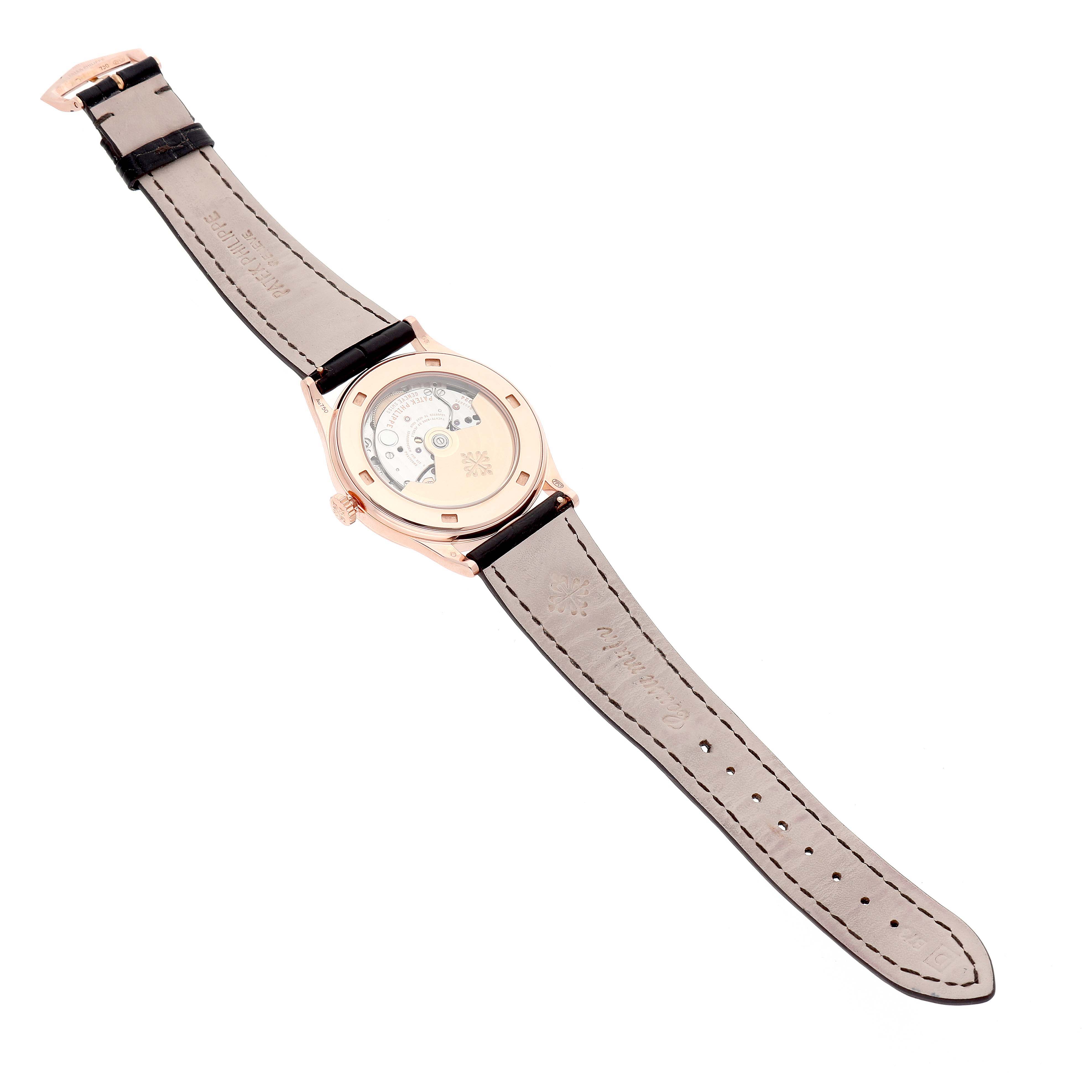 The image shows the back view of a Patek Philippe Calatrava 5296R-010 Men's Rose Gold Silver Dial watch, highlighting the exposed movement and leather strap.