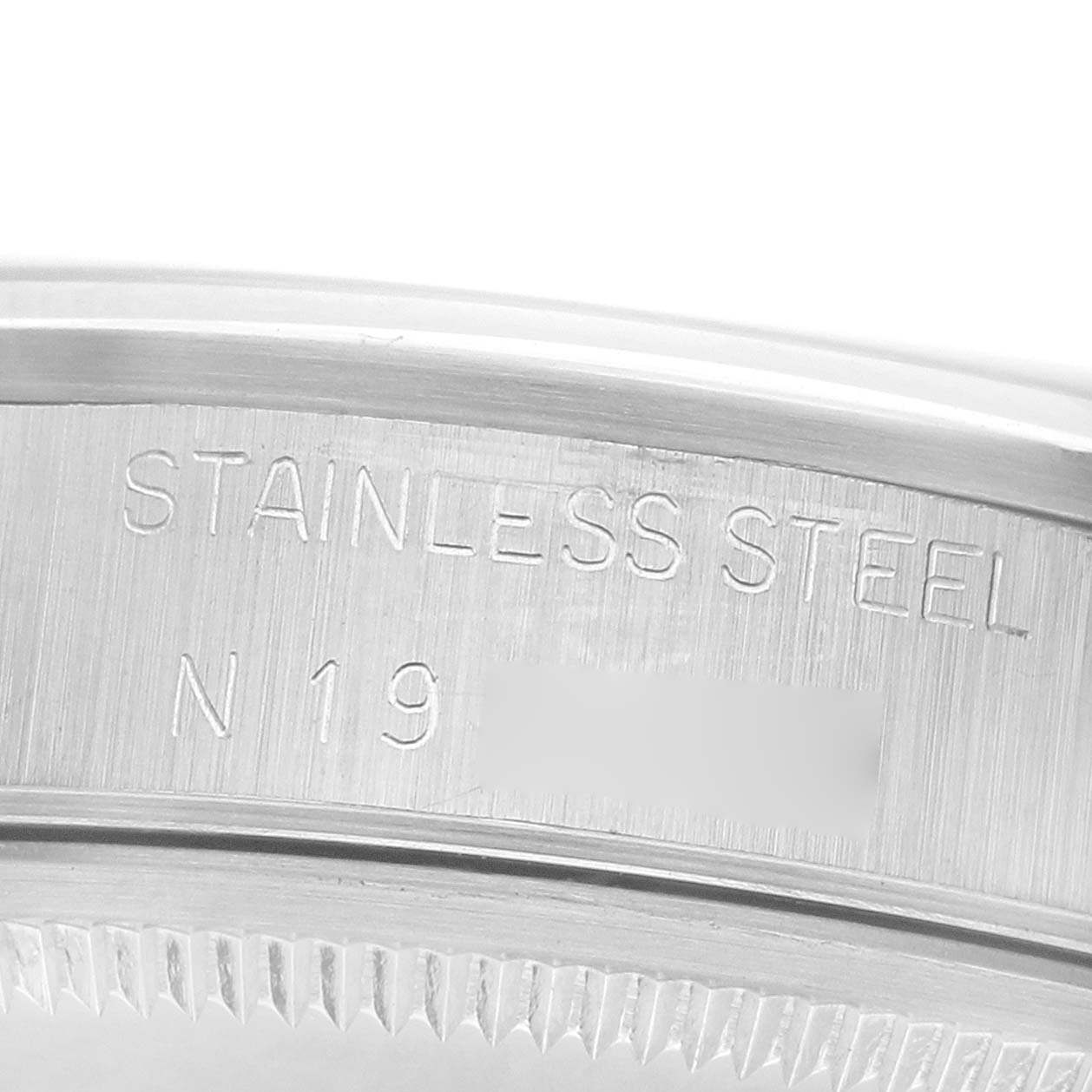 The image shows a close-up of the Rolex Air-King 14000 Men's Stainless Steel Black Dial's stainless steel bezel engraving.