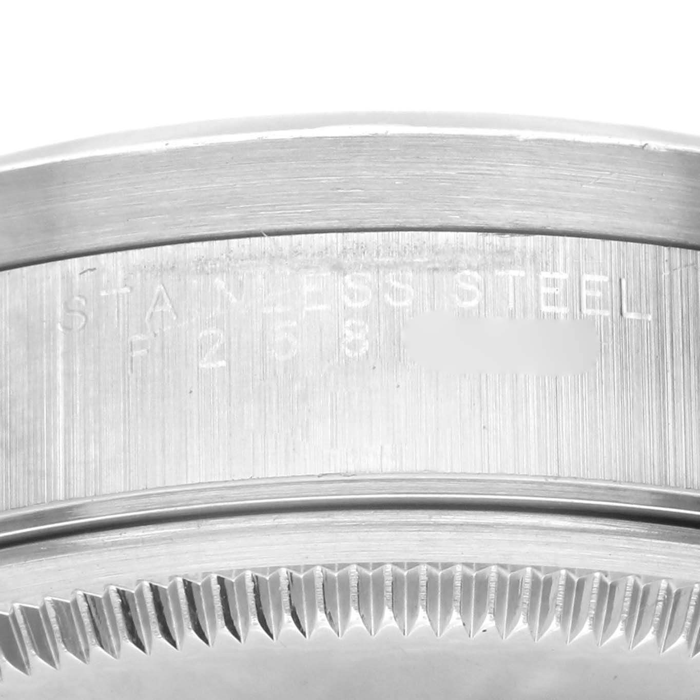This image shows a close-up of the stainless steel casing and serial number engraving on the side of a Rolex Air-King 14010M Men's Stainless Steel Blue Dial 14010M Men's Stainless Steel Blue Dial watch.