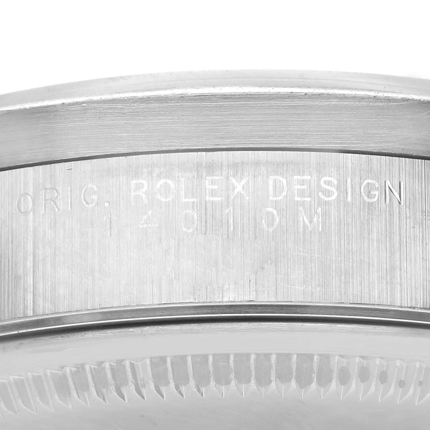 The image shows an up-close view of the engraved side of a Rolex Air-King 14010M Men's Stainless Steel Blue Dial 14010M Men's Stainless Steel Blue Dial watch case, focusing on the serial number and branding.