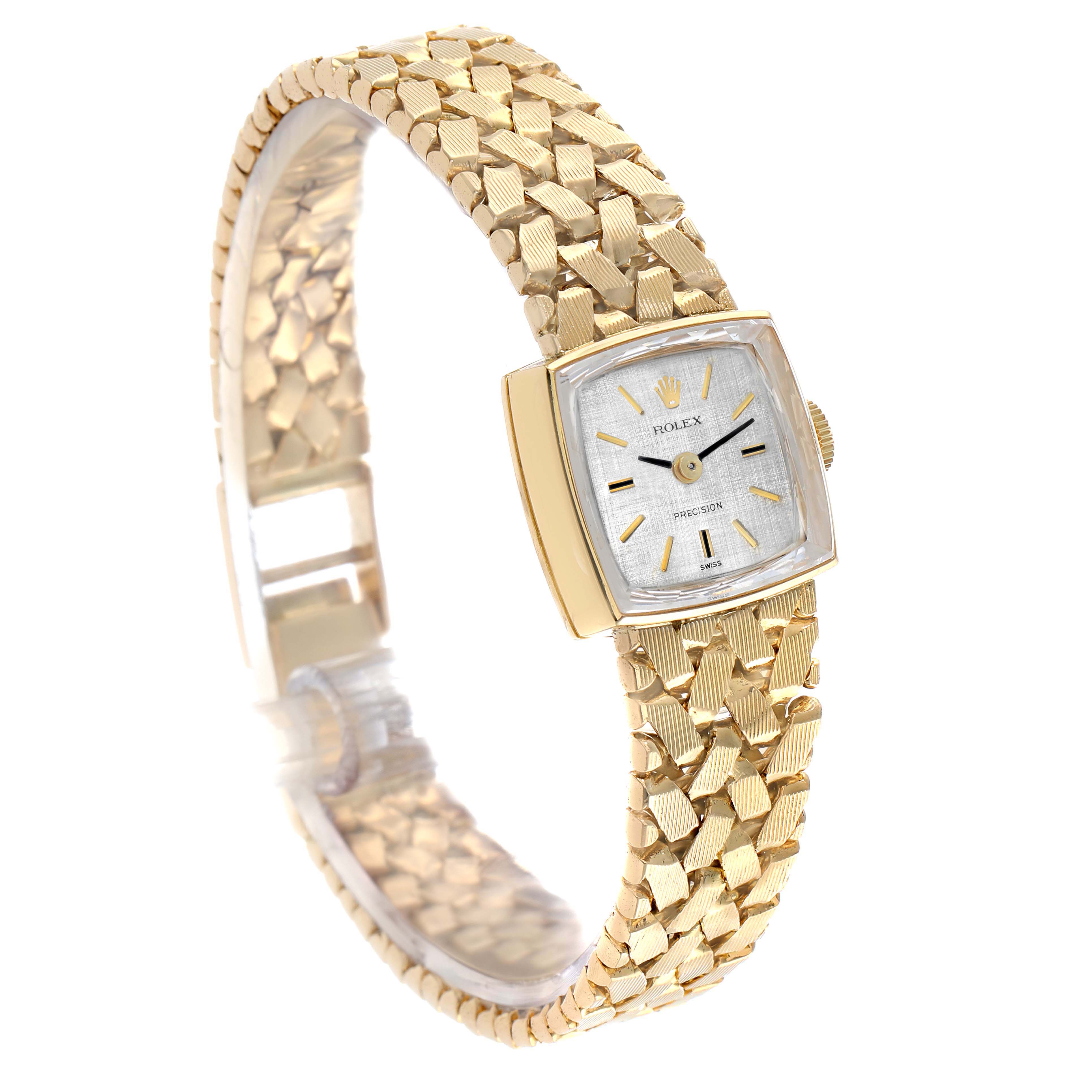 The Rolex Cocktail 8298 Women's Yellow Gold Silver Dial watch is shown from a high angle, highlighting its square face, gold bracelet, and textured pattern.