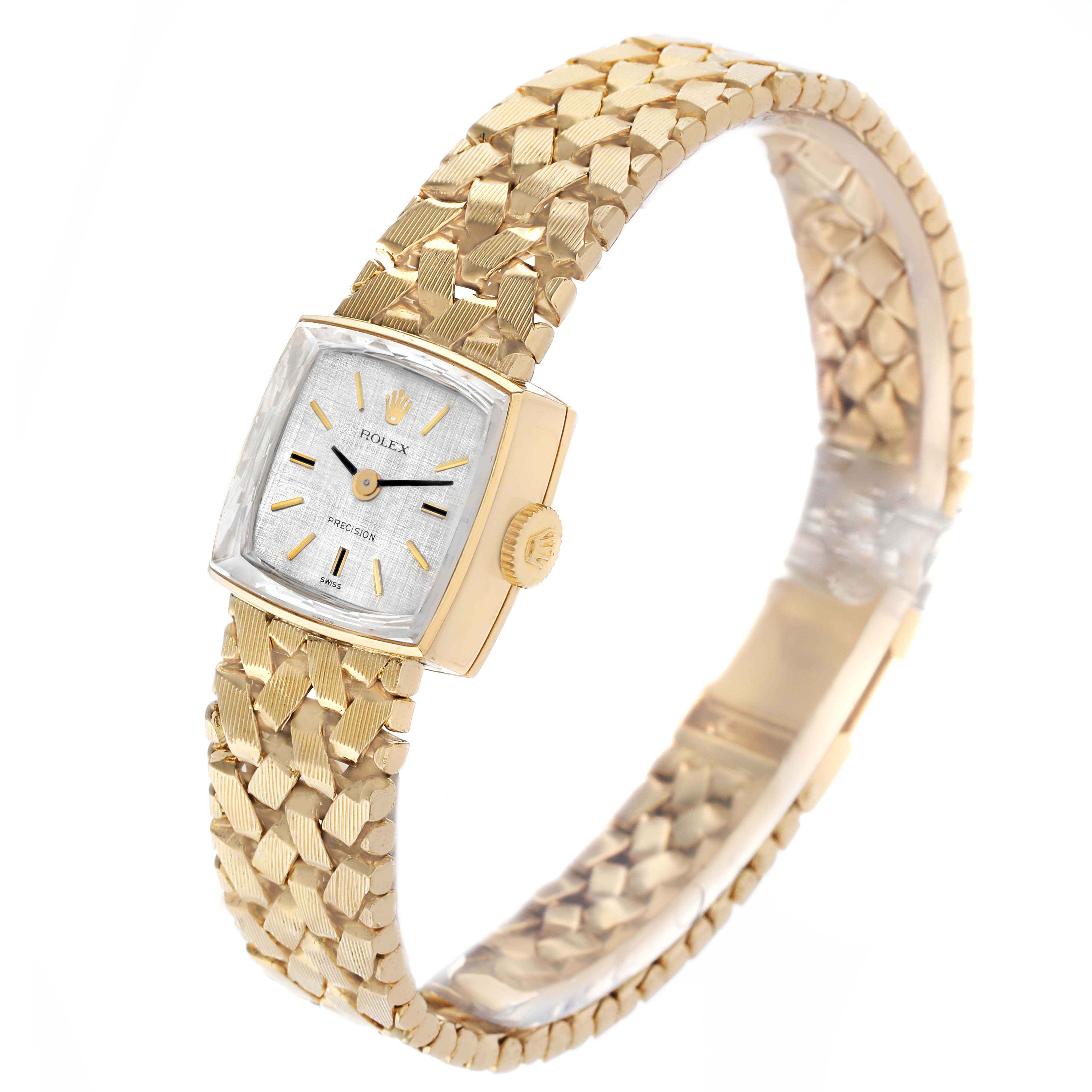 The Rolex Cocktail 8298 Women's Yellow Gold Silver Dial watch is shown at an angled side view, highlighting its face, crown, and textured bracelet.