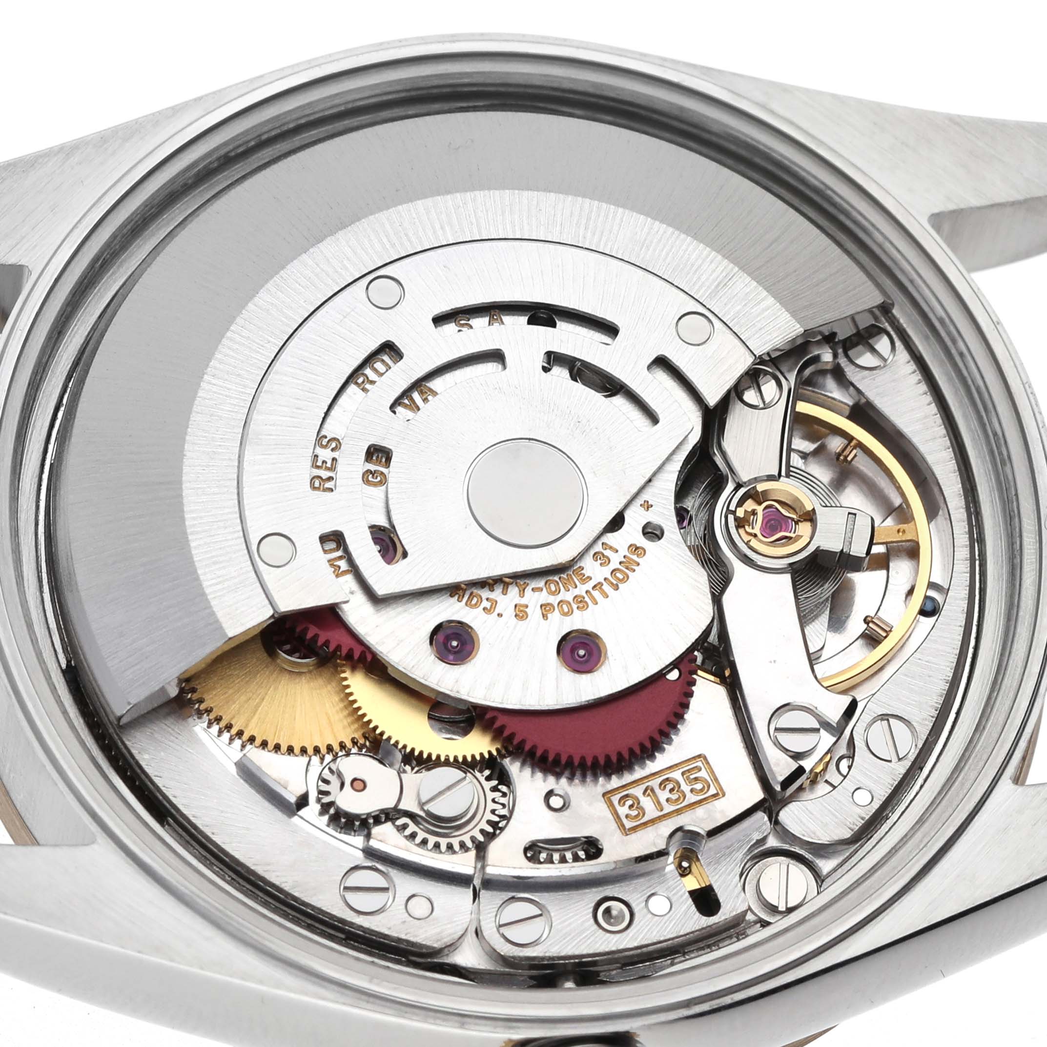 The image shows the Rolex Date 15203 Men's Steel and Gold (two tone) Champagne Dial model's movement, revealing various gears and components from a rear angle.