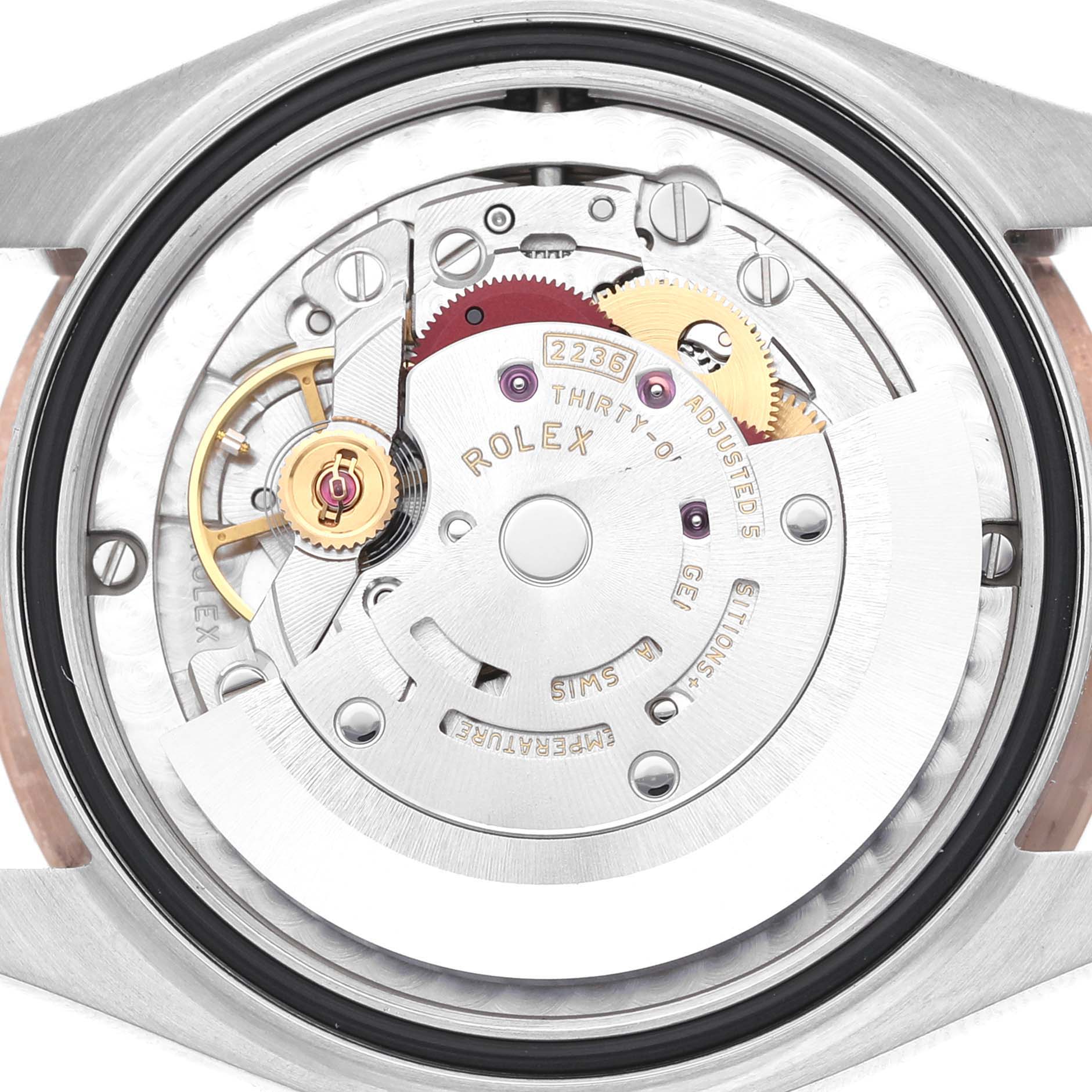 The image shows the movement of a Rolex Mid-Size 278381RBR-0020 Womens Stainless Steel Grey Dial model viewed from the back, revealing gears and components.