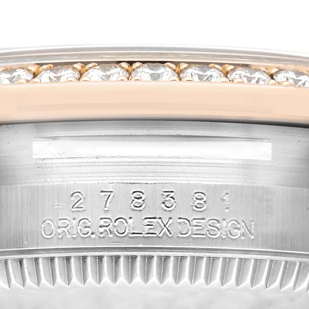 The image shows the side view of a Rolex Mid-Size 278381RBR-0020 Womens Stainless Steel Grey Dial models bezel and case, featuring a diamond-set bezel and engraved details.