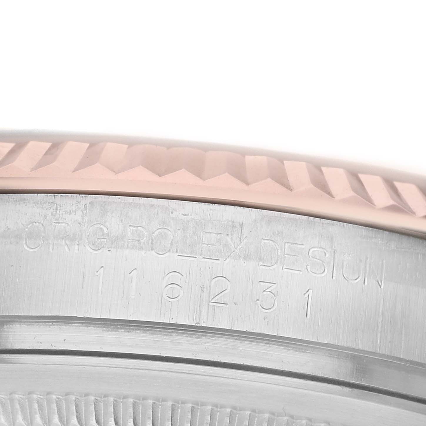 The image shows a close-up of the engraved side of the case and fluted bezel on a Rolex Datejust 116231 Men's Steel and Gold (two tone) Silver Dial watch.
