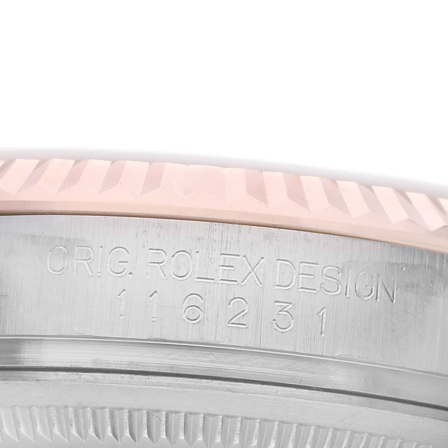 The image shows a close-up of the case side of a Rolex Datejust 116231 Men's Steel and Gold (two tone) Silver Dial, highlighting the bezel and engraved design number.