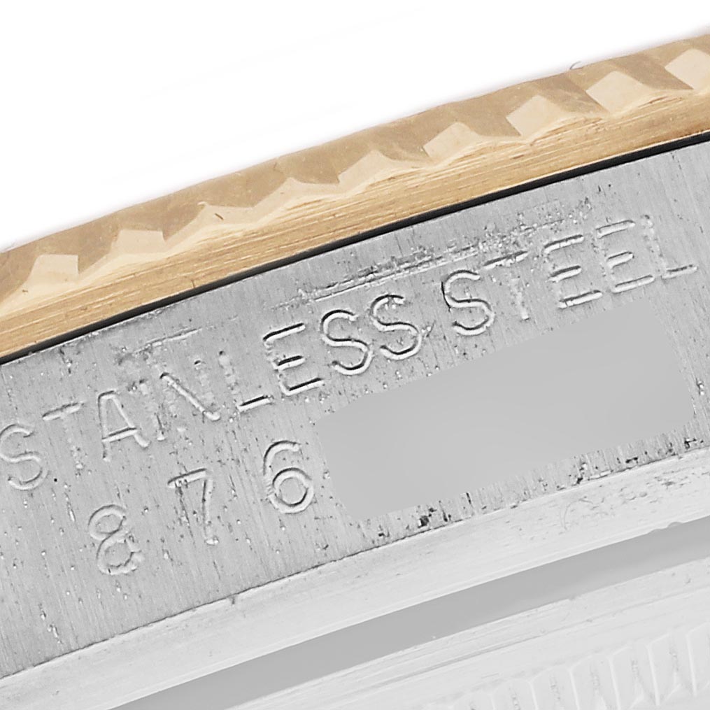 The Rolex Datejust 16013 Men's Steel and Gold (two tone) Champagne Dial image shows a close-up of the watch's stainless steel case with engraved markings.