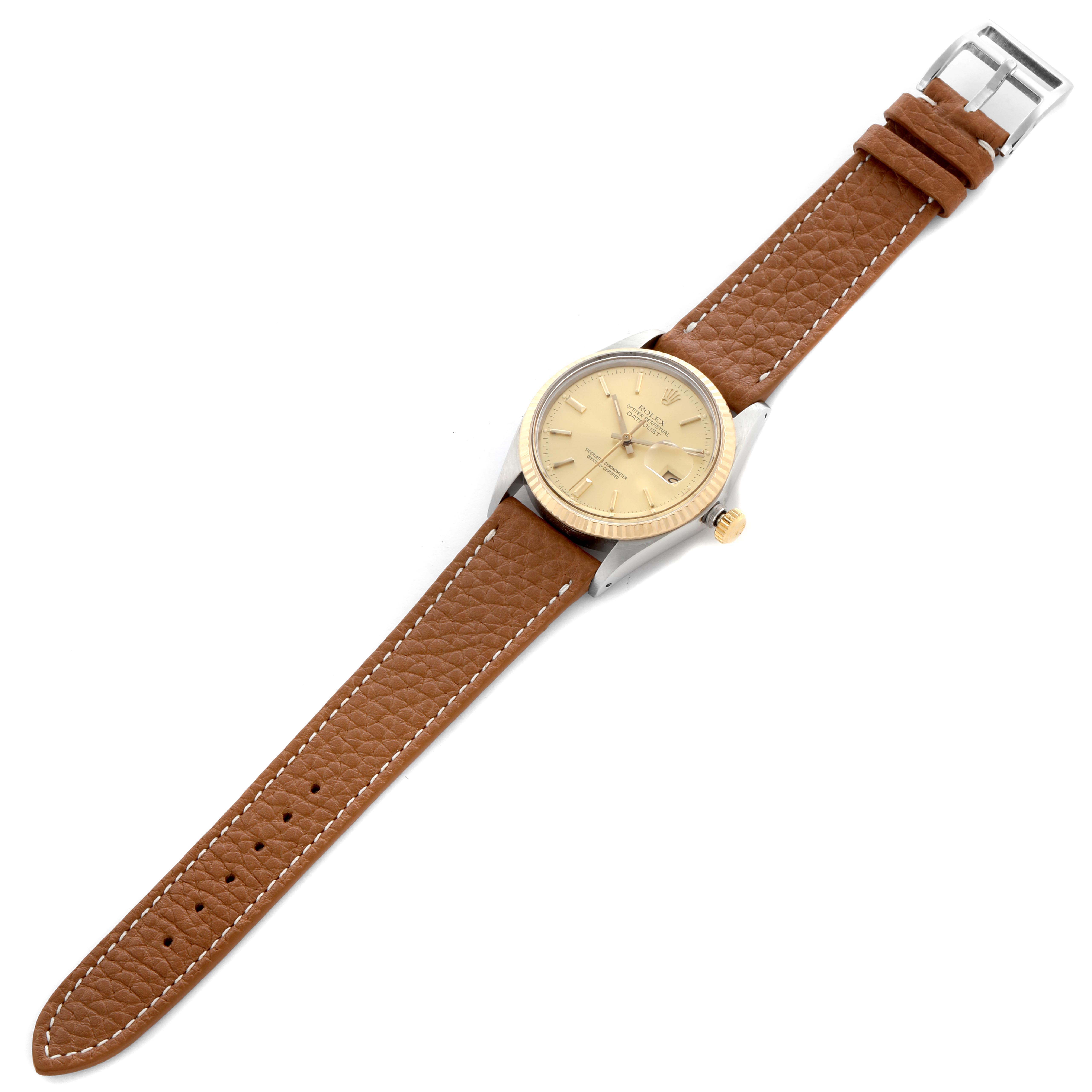 The Rolex Datejust 16013 Men's Steel and Gold (two tone) Champagne Dial watch is shown from a top angle, highlighting its face, bezel, crown, and brown leather strap.