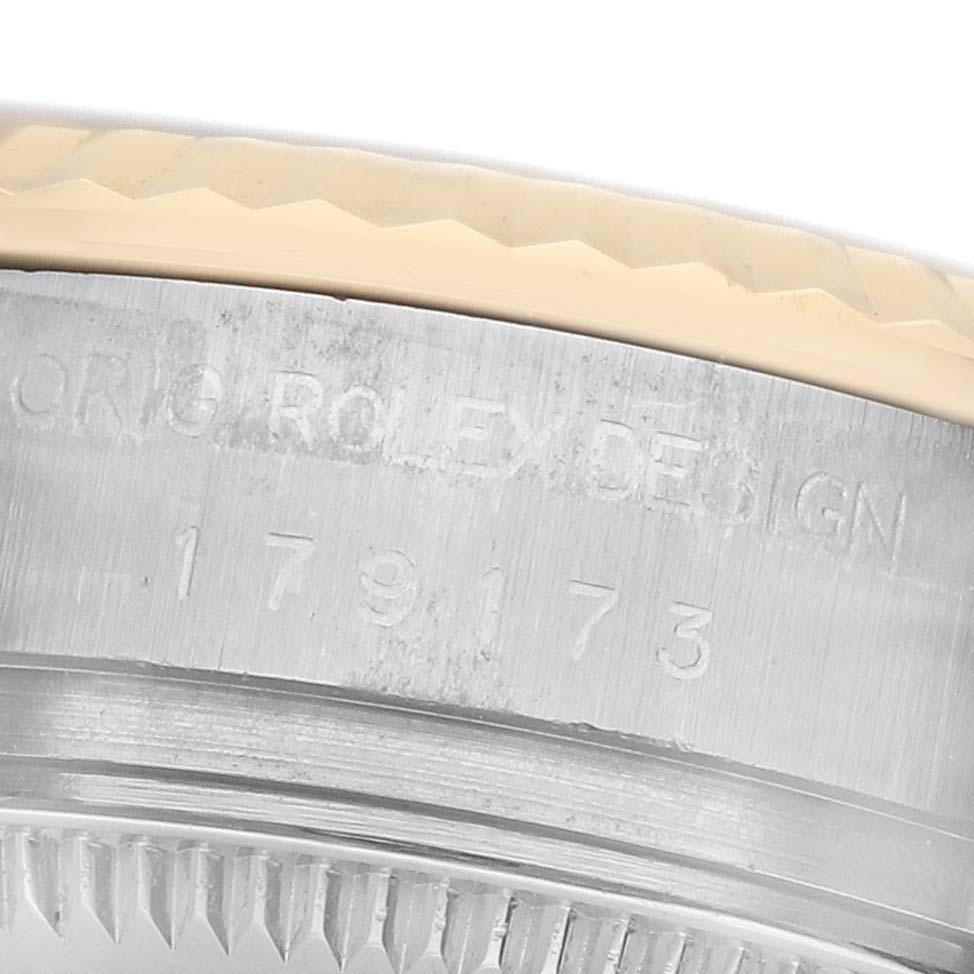 The image shows a close-up of the case side of a Rolex Datejust 179173 Women's Steel and Gold (two tone) Silver Dial, highlighting the engraved "ORIG ROLEX DESIGN" and serial number.