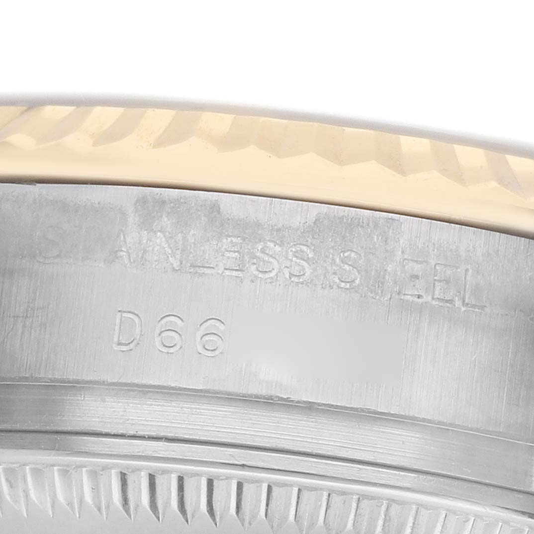 The image shows a close-up of the stainless steel side and fluted bezel of a Rolex Datejust 179173 Women's Steel and Gold (two tone) Silver Dial watch.