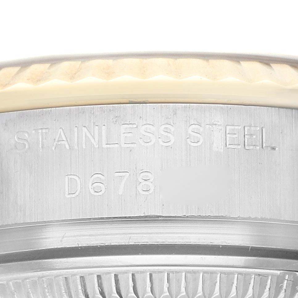 The image shows a close-up of the side of a Rolex Datejust 179173 Women's Yellow Gold Champagne Dial watch case, highlighting the stainless steel and part of the fluted bezel.