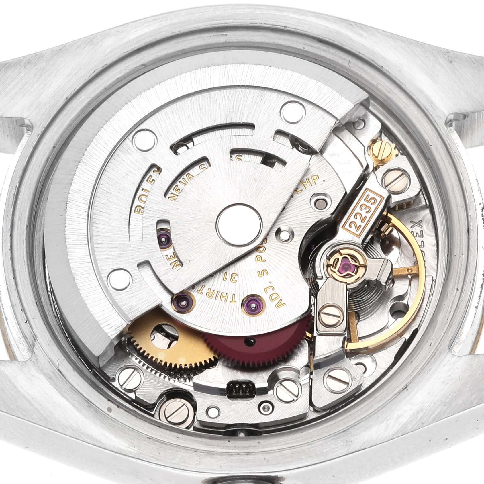 The image shows the movement mechanism of a Rolex Datejust 179173 Women's Yellow Gold Champagne Dial watch from the back, highlighting gears and balance wheel.