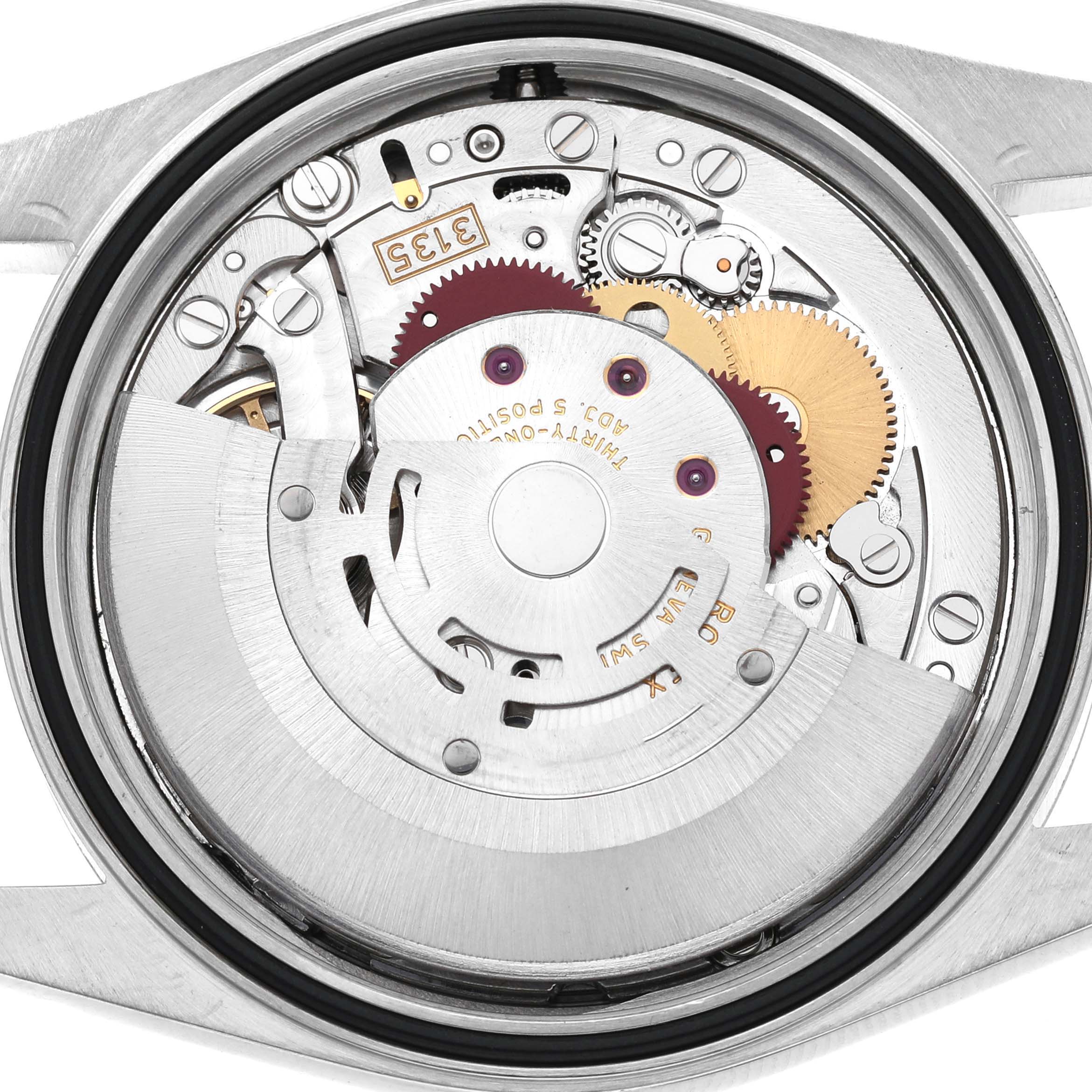 This image shows the internal mechanism of a Rolex Datejust 16200 Mens Stainless Steel Silver Dial model, revealing the gears and movement parts from a close-up angle.