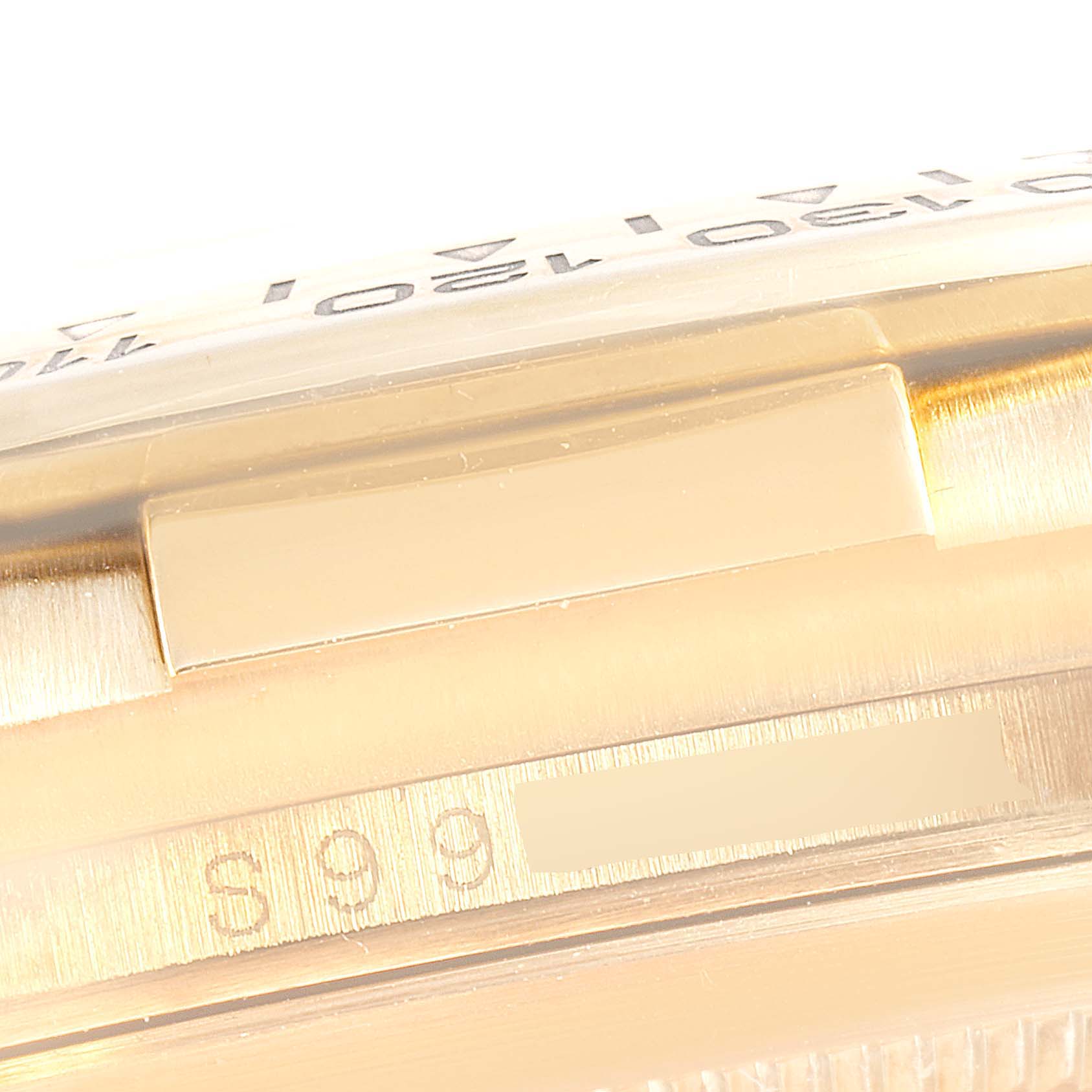 The image shows the side of a Rolex Daytona 16518 Men's Yellow Gold White Dial 16518 Men's Yellow Gold White Dial watch case, highlighting the engraved serial number.