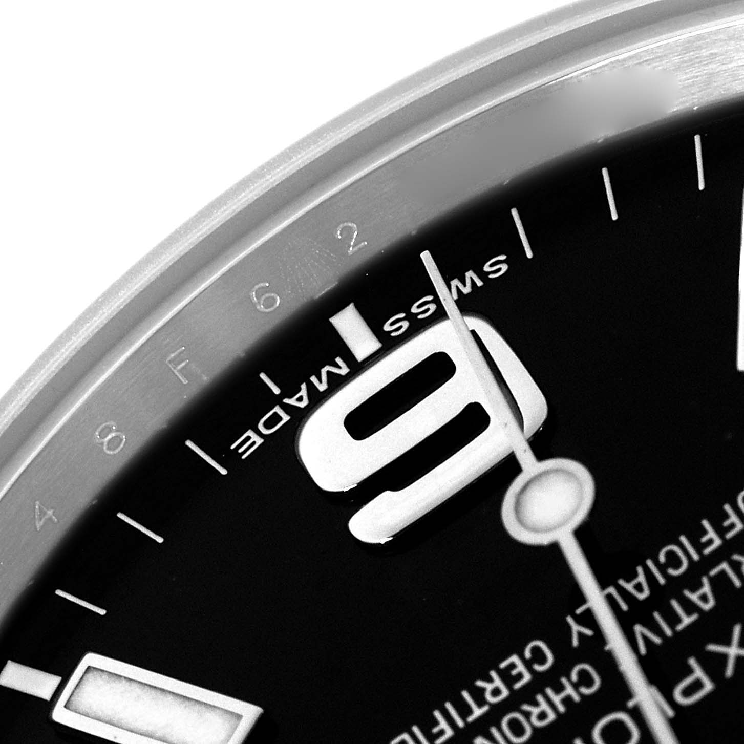 The image shows a close-up of the dial and hands of a Rolex Explorer 214270 Men's Stainless Steel Black Dial, focusing on the numeral "9" and the "Swiss Made" text.
