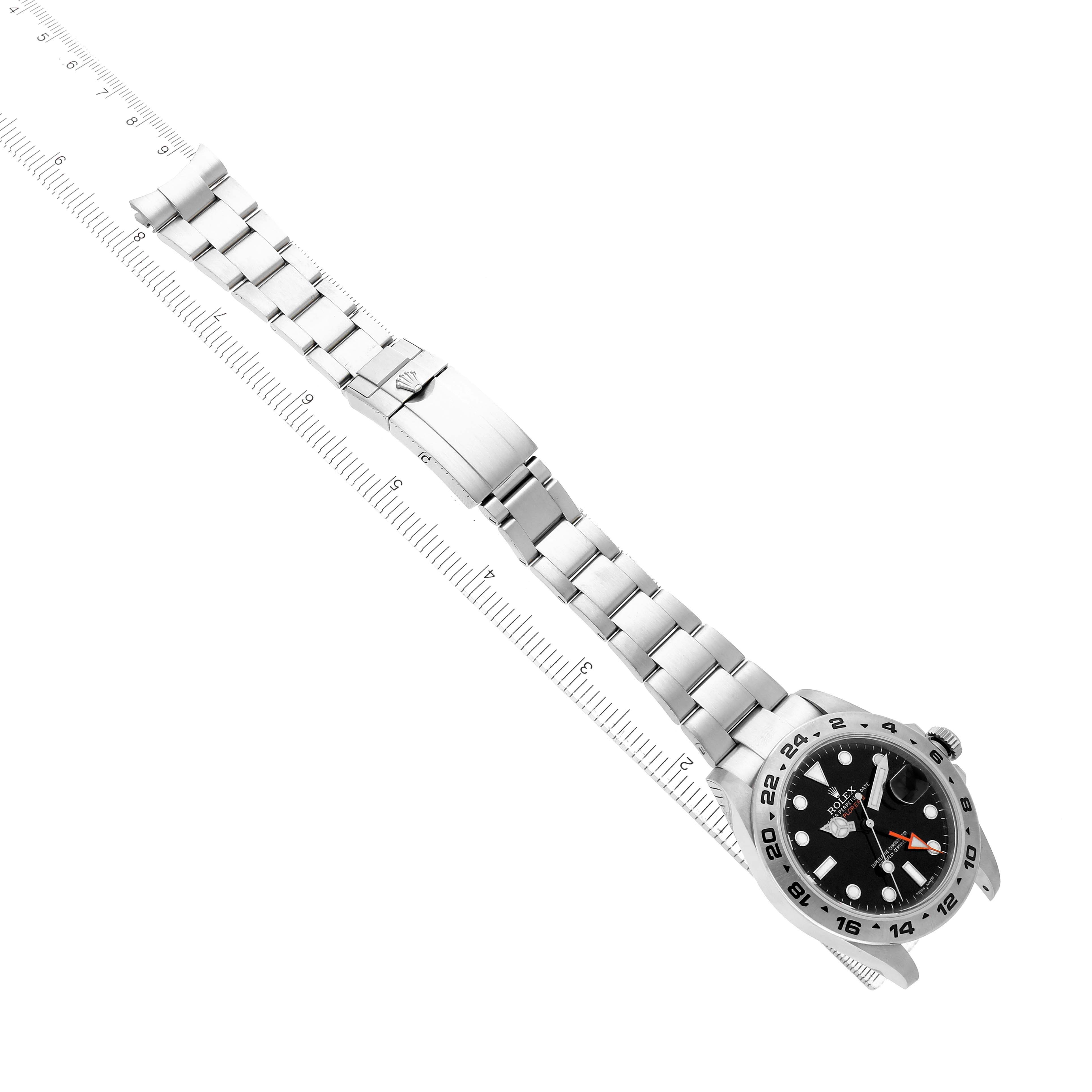 The Rolex Explorer 216570 Men's Stainless Steel Black Dial watch is shown at an angle, displaying the full bracelet, clasp, and face.