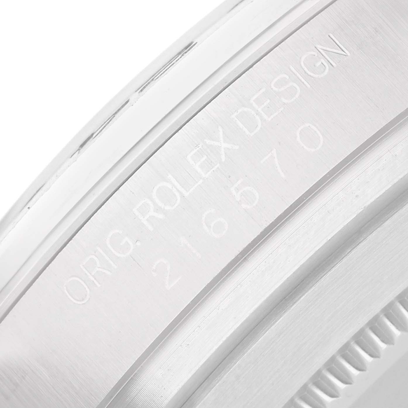 The image shows a close-up of the side engraving on the bezel of a Rolex Explorer 216570 Men's Stainless Steel Black Dial watch, model number visible.