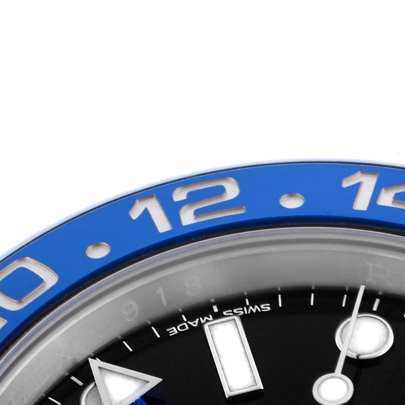 This image shows a close-up of the blue bezel and part of the dial of a Rolex GMT-Master 116710BLNR Men's Stainless Steel Black Dial watch.