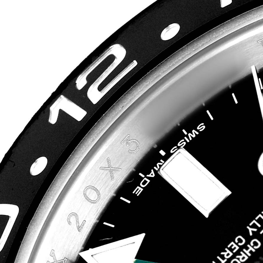 The image shows a close-up of the bezel and dial edge of a Rolex GMT-Master 116710 Men's Stainless Steel Black Dial, highlighting part of the 12-hour marker.