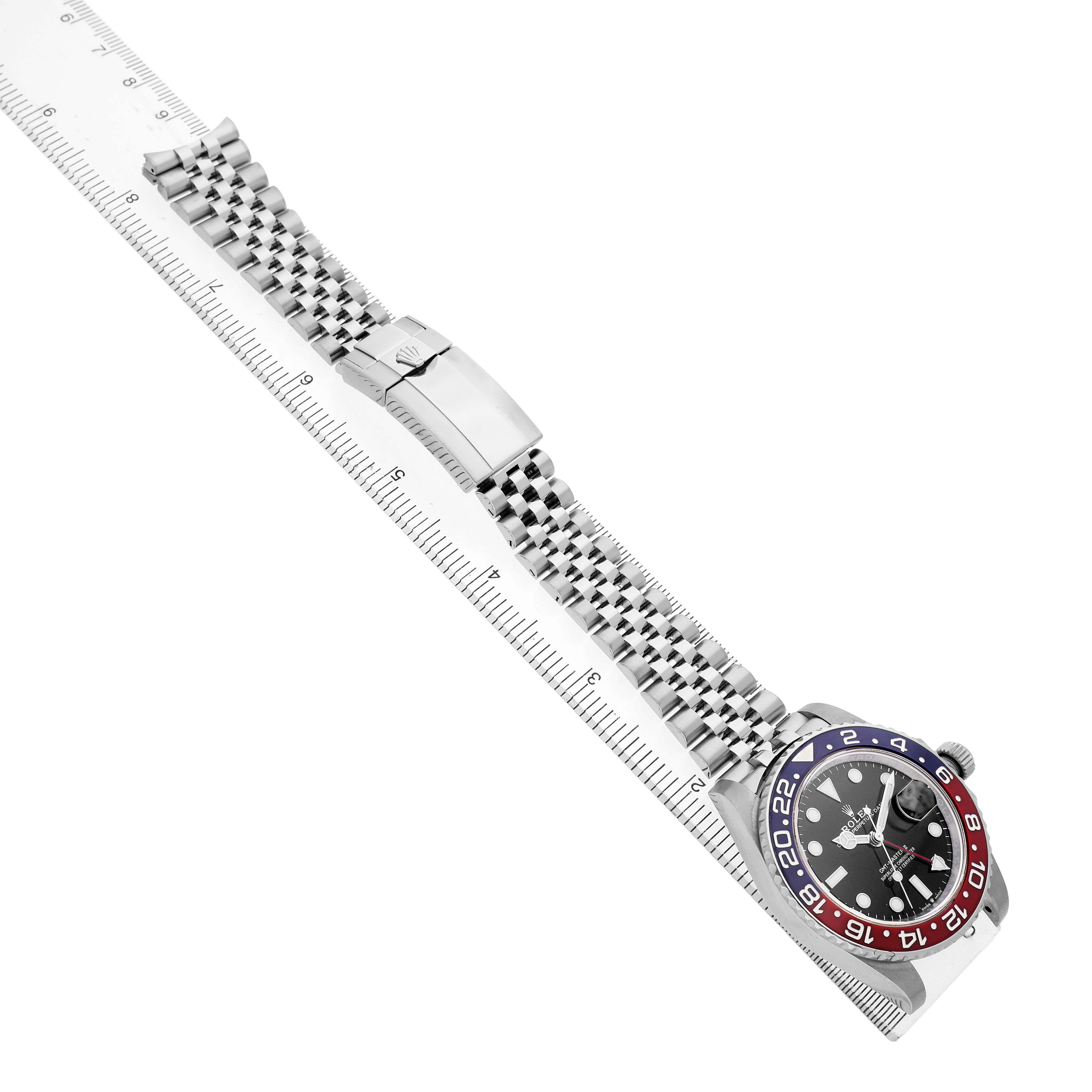 The image shows a Rolex GMT-Master 126710BLRO Men's Stainless Steel Black Dial watch at an angled view, displaying the bracelet and the "Pepsi" bezel next to a ruler.