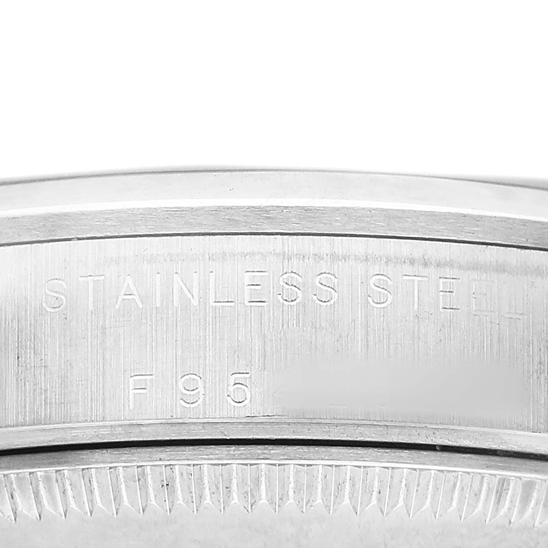 The image shows a close-up of the side profile and engravings on the Oyster Perpetual by Rolex, focusing on the stainless steel marking.