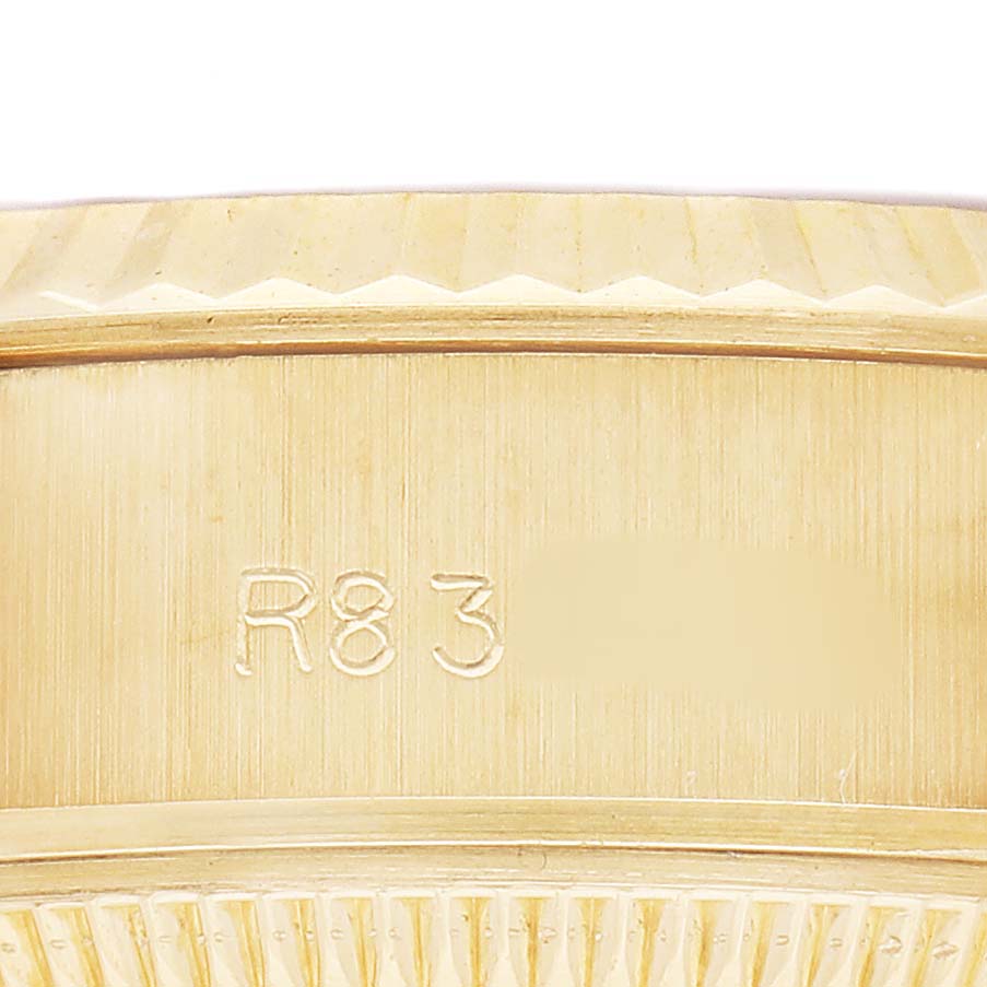 The image shows a detailed view of the side of a Rolex President 69178 Women's Yellow Gold Champagne Dial watch, focusing on the serial number engraved on the case.