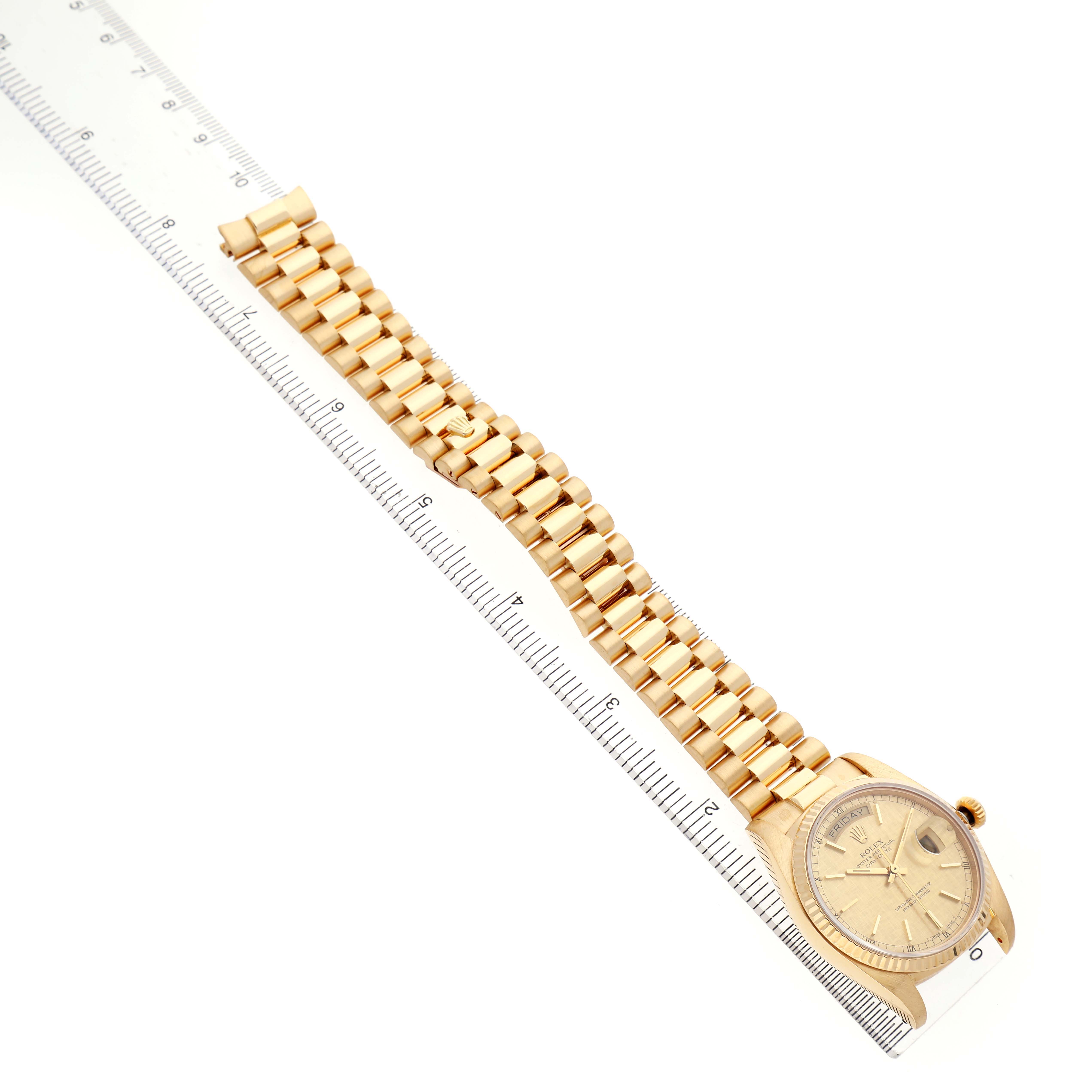 The photo shows a Rolex President 18038 Men's Yellow Gold Champagne Dial watch at an angle, displaying its gold case, bracelet, and part of the dial, alongside a ruler.
