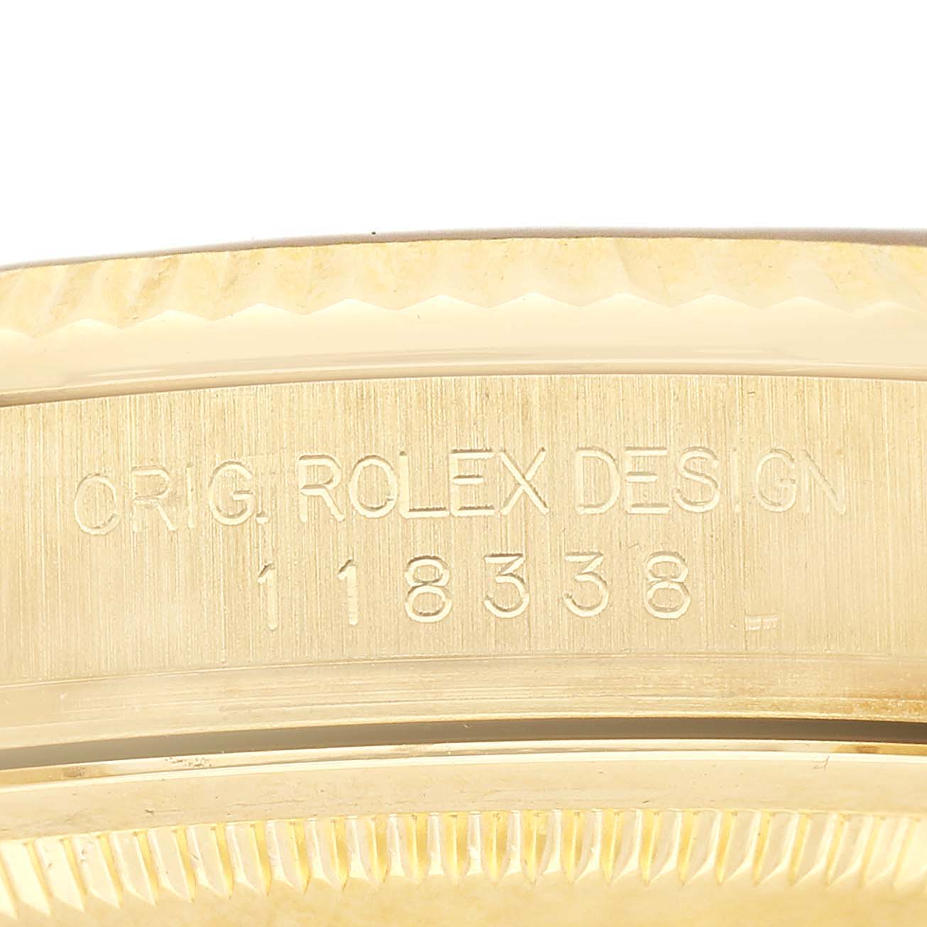 The image shows a close-up of the side of a Rolex President 118338 Mens Yellow Gold Champagne Dial watch, highlighting engravings on the case.