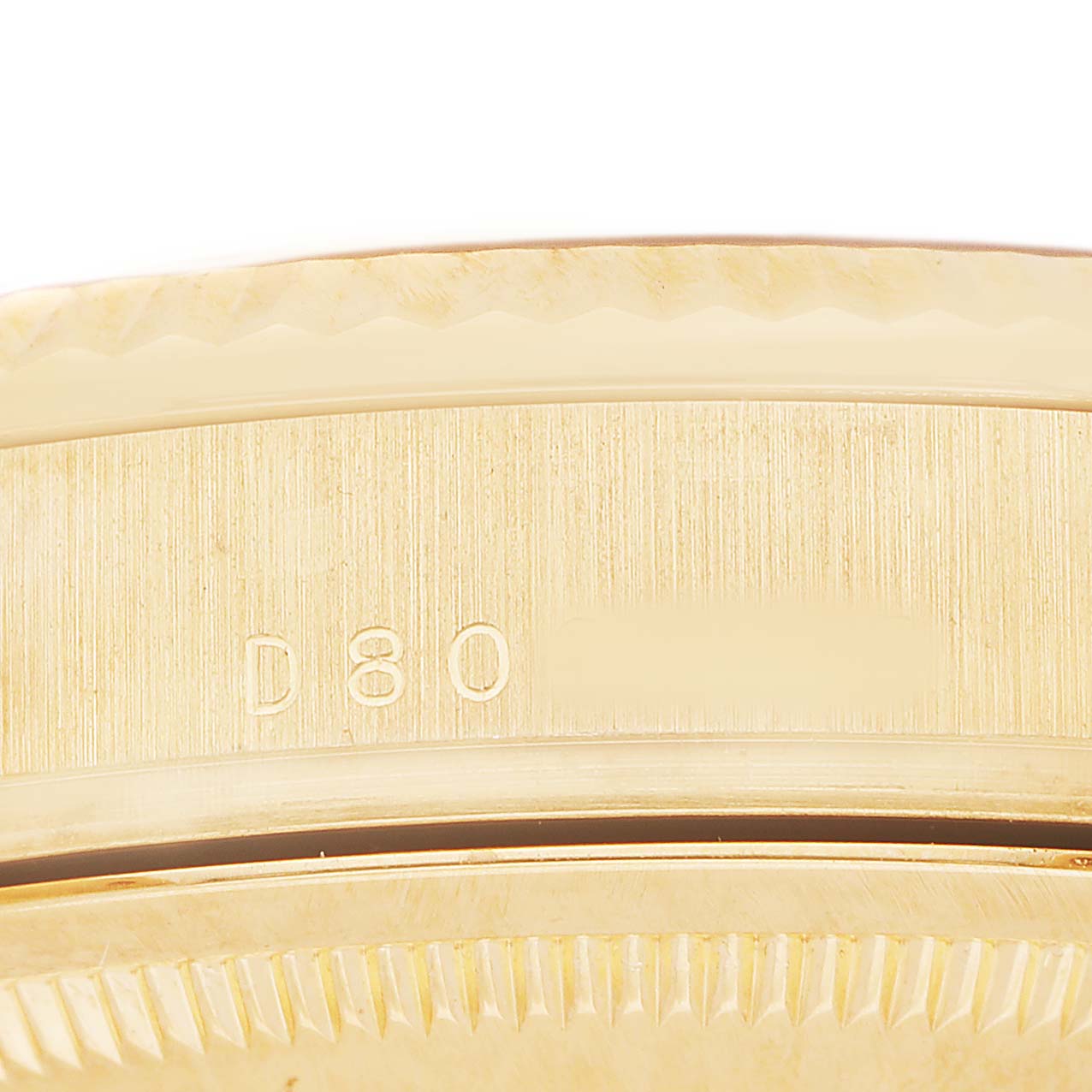 The image shows a close-up of the case edge with engravings on a Rolex President 118338 Mens Yellow Gold Champagne Dial model.