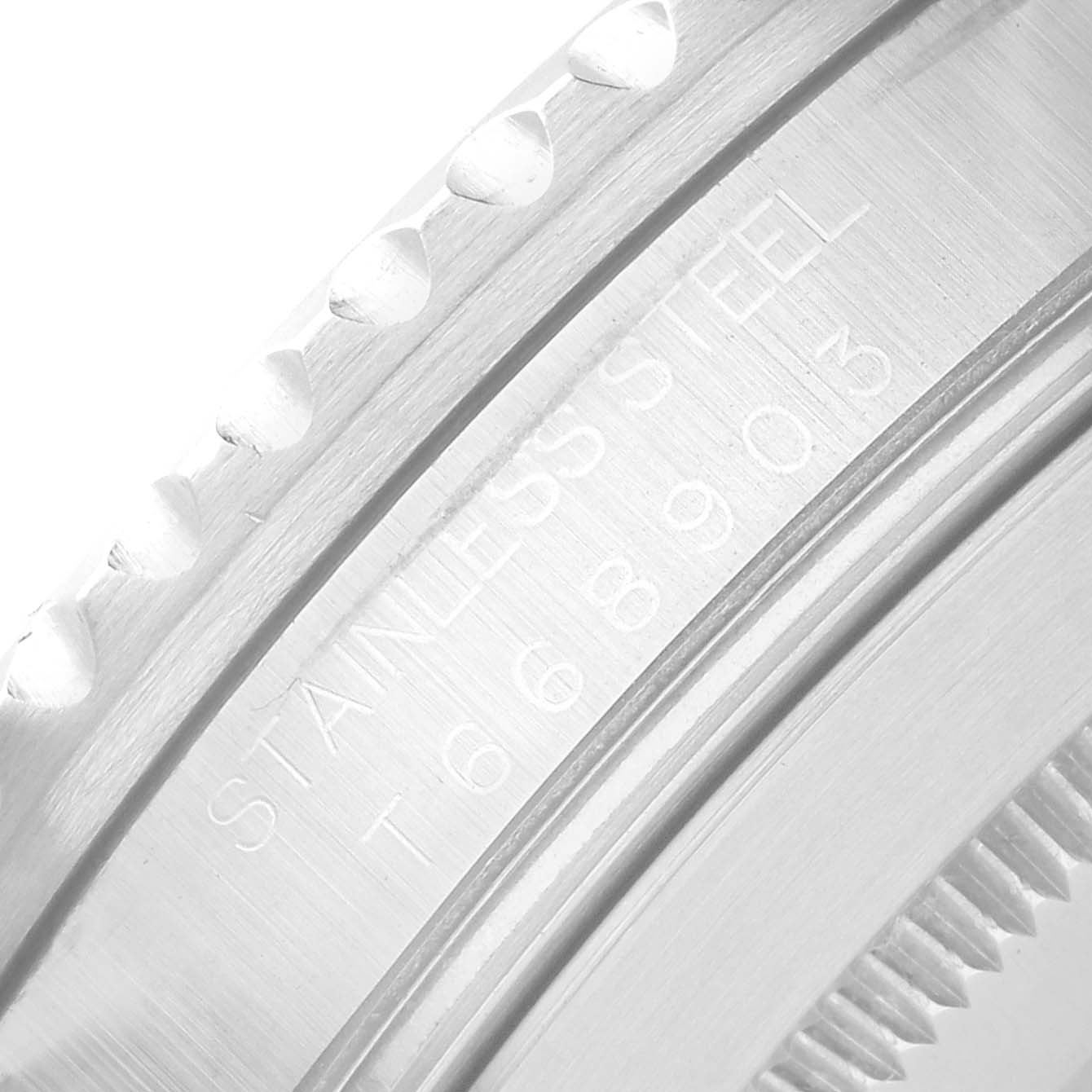 The image shows a close-up of the side engraving and bezel teeth of a Rolex Submariner 16610 Men's Stainless Steel Black Dial watch.