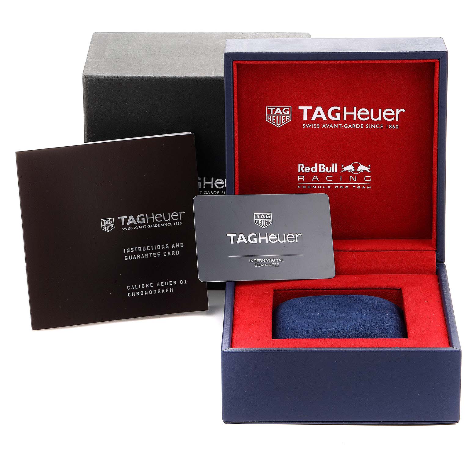 This image shows the Tag Heuer Carrera CAR2A1K.BA0703 Men
s Stainless Steel Blue Dial CAR2A1K.BA0703 Men
s Stainless Steel Blue Dial watch box, guarantee card, and instruction manual from a frontal angle.