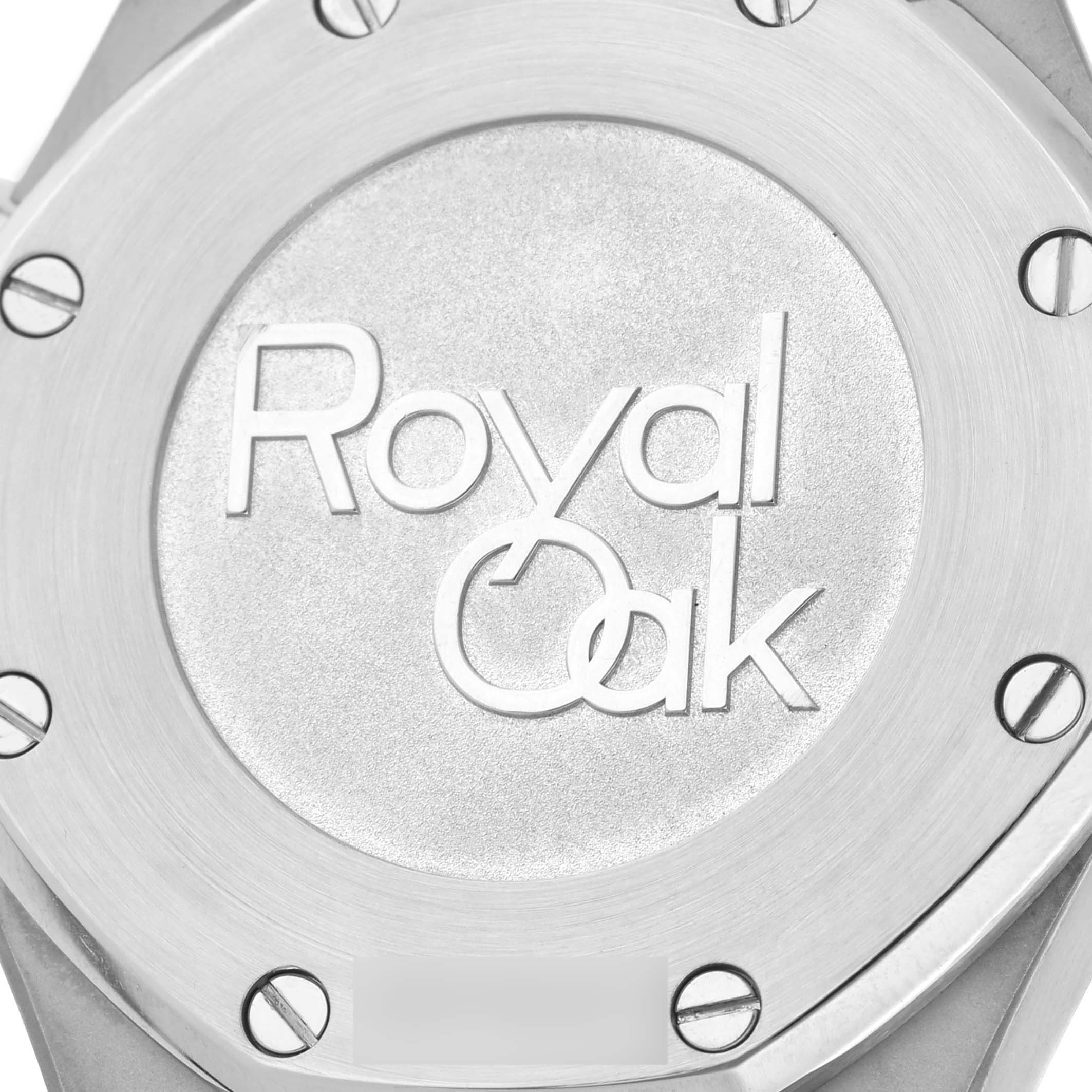 This close-up image shows the back case of a Royal Oak model by Audemars Piguet, featuring brushed metal and visible screws.