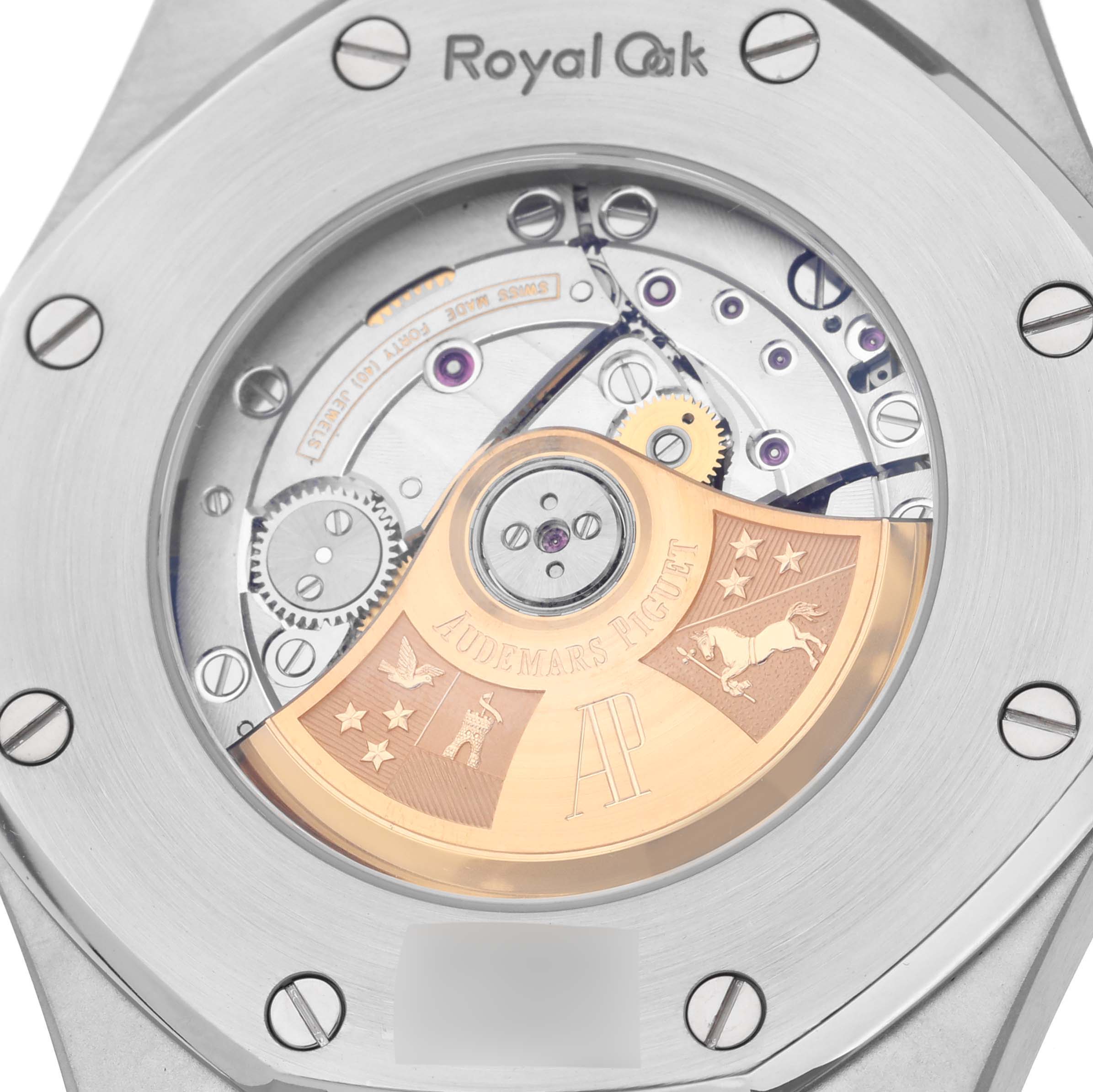 The image shows the intricate case back of the Audemars Piguet Royal Oak 15400ST.OO.1220ST.01 Men's Stainless Steel Black Dial 15400ST.OO.1220ST.01 Men's Stainless Steel Black Dial model, showcasing the movement with visible gears and a gold-toned rotor.