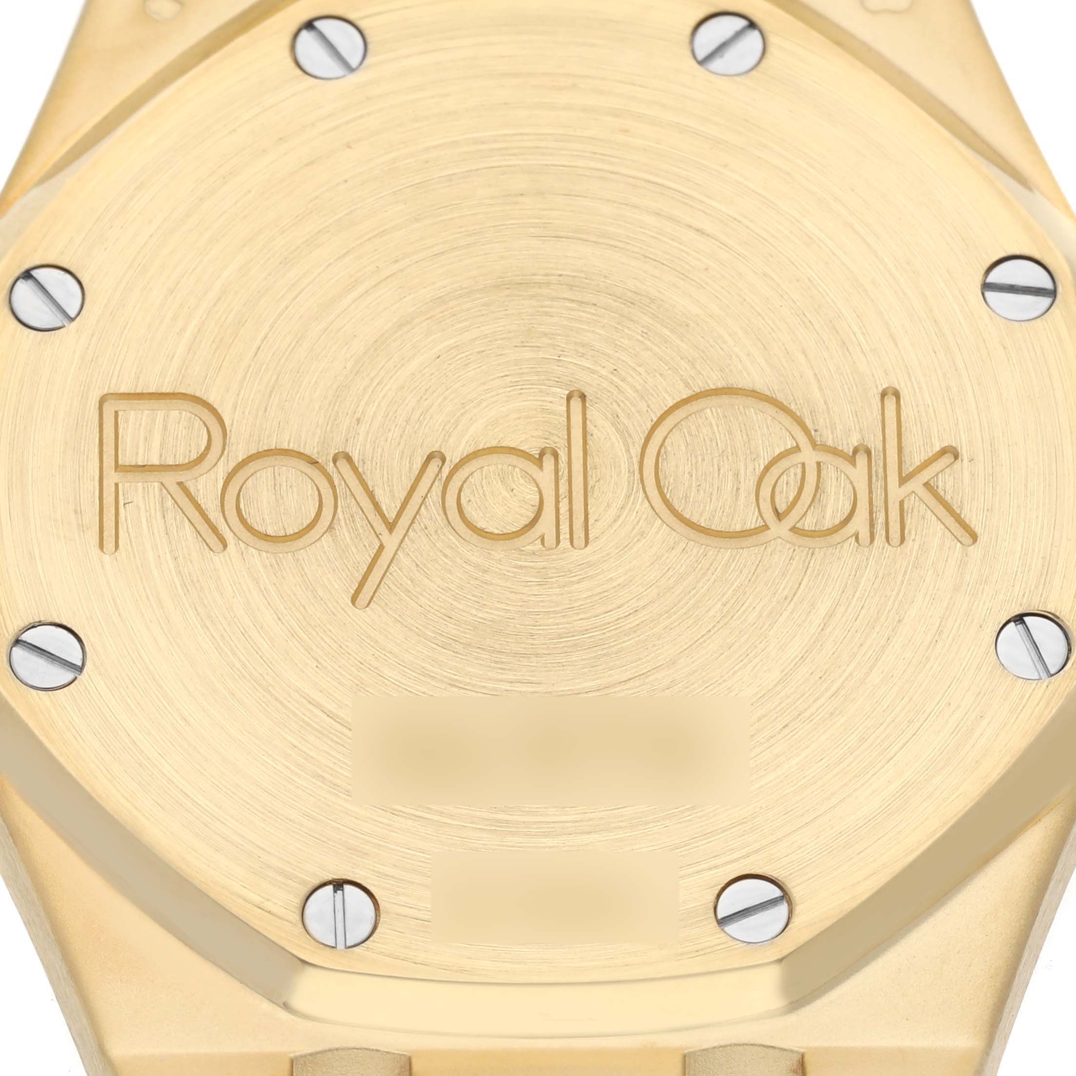 The image shows the back case of a Royal Oak watch by Audemars Piguet, focusing on the engraved logo and screw details.