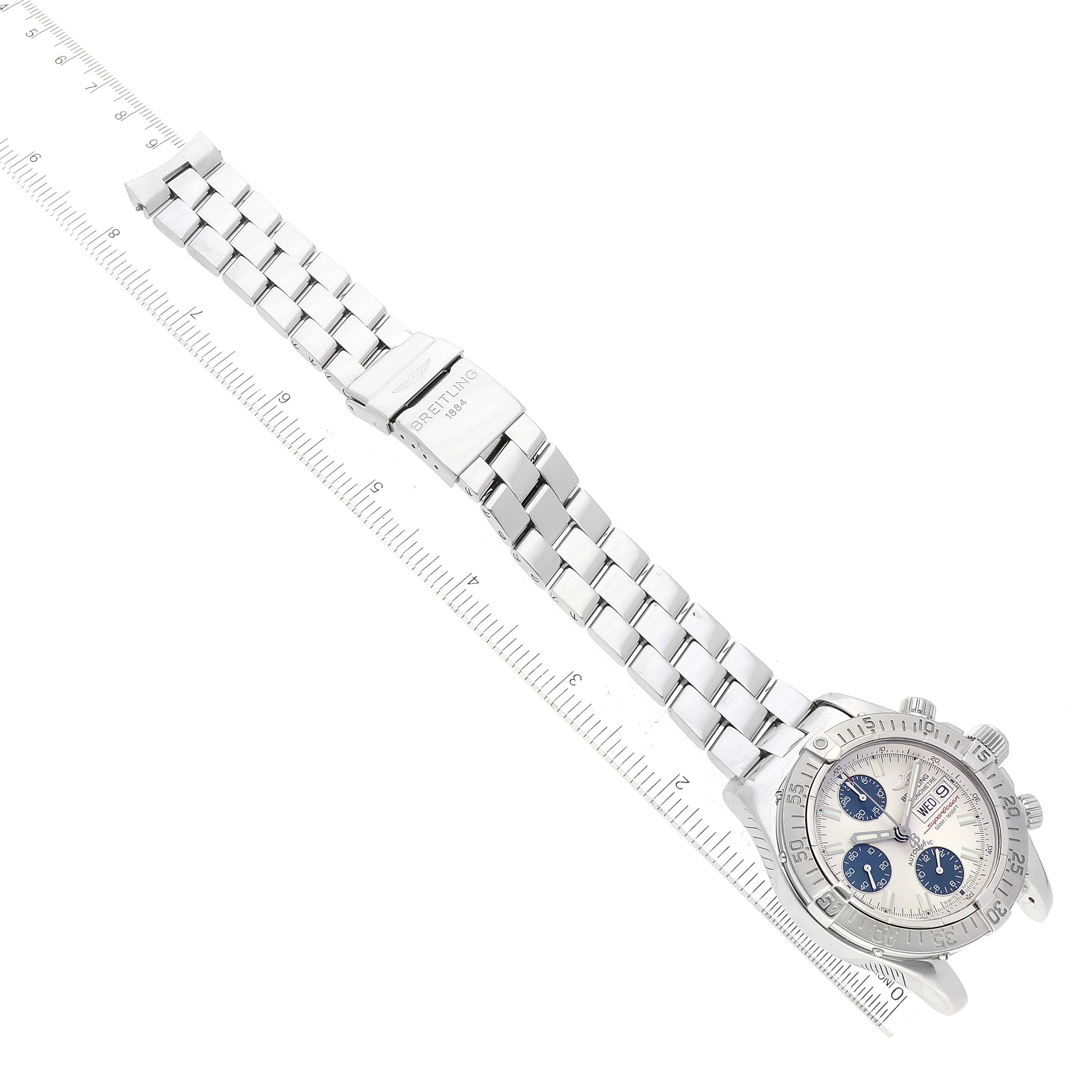 The image shows a top-down view of a Breitling Superocean A13340 Men's Stainless Steel Silver Dial A13340 Men's Stainless Steel Silver Dial watch, displaying the face, bezel, bracelet, and clasp.