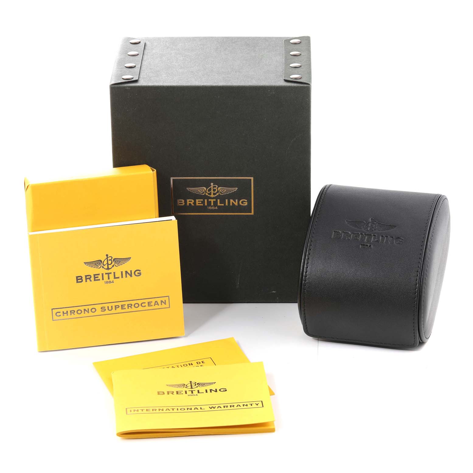 This image shows the packaging and accessories for a Breitling Superocean A13340 Men's Stainless Steel Silver Dial A13340 Men's Stainless Steel Silver Dial watch, including boxes and booklets.