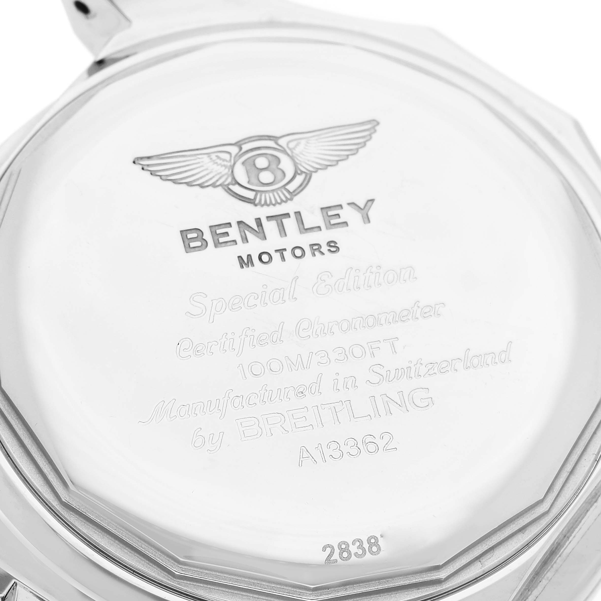 The image shows the engraved case back of a Bentley model watch by Breitling, taken from a top-down angle.