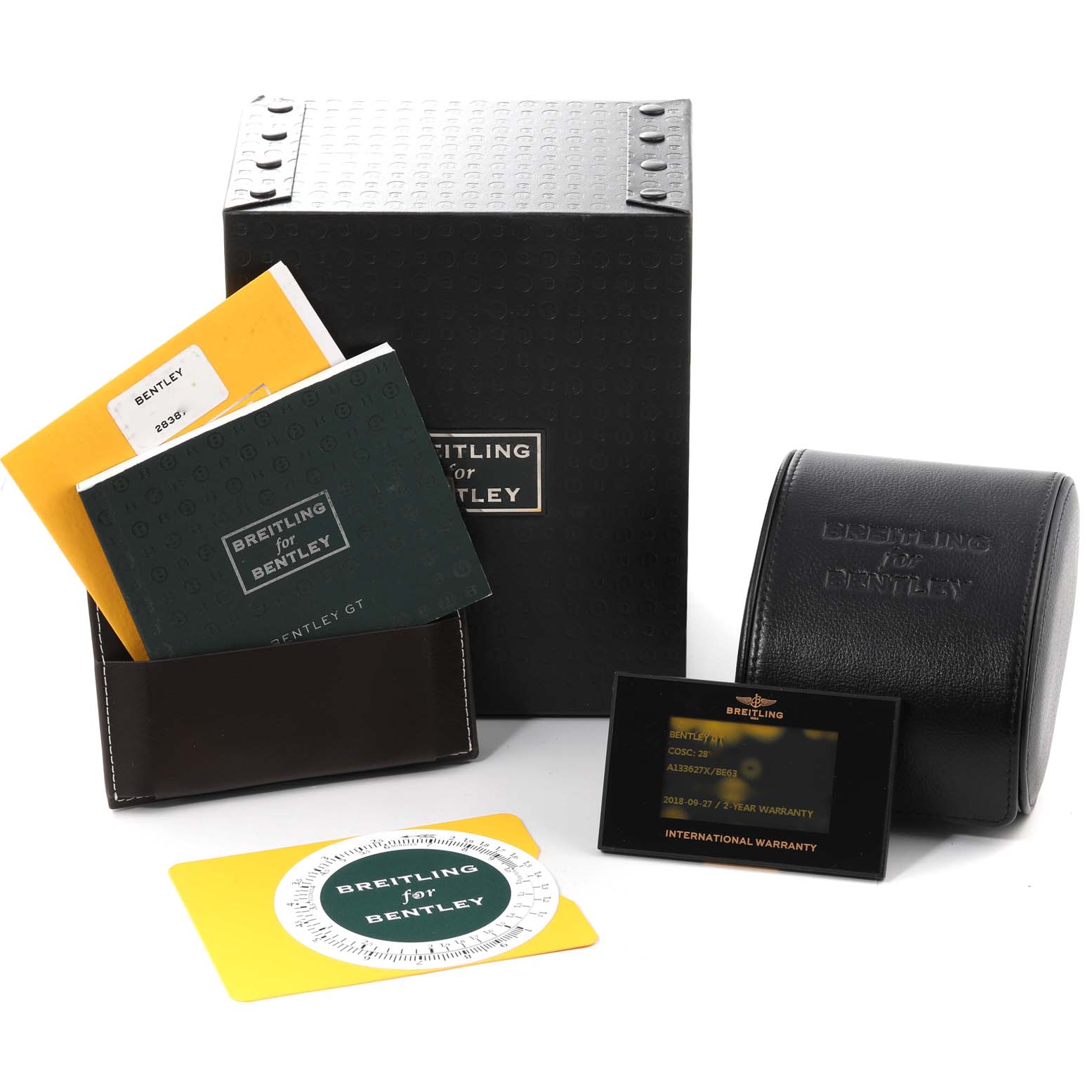The image shows packaging and accessories for a Bentley model Breitling watch, including manuals, a warranty card, and a leather watch case.