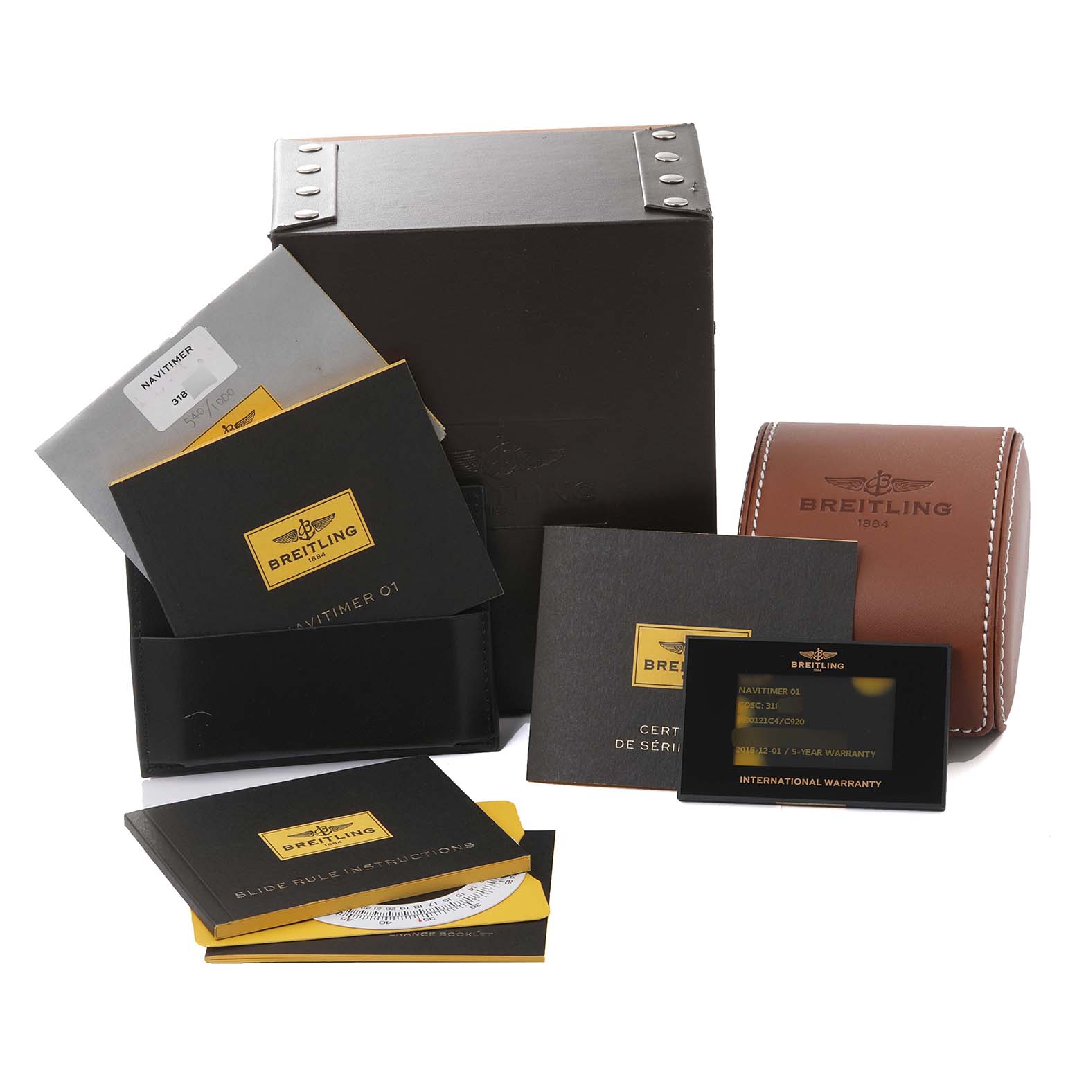 The image shows the packaging, manuals, and warranty card for the Breitling Limited Series Navitimer 01 watch.