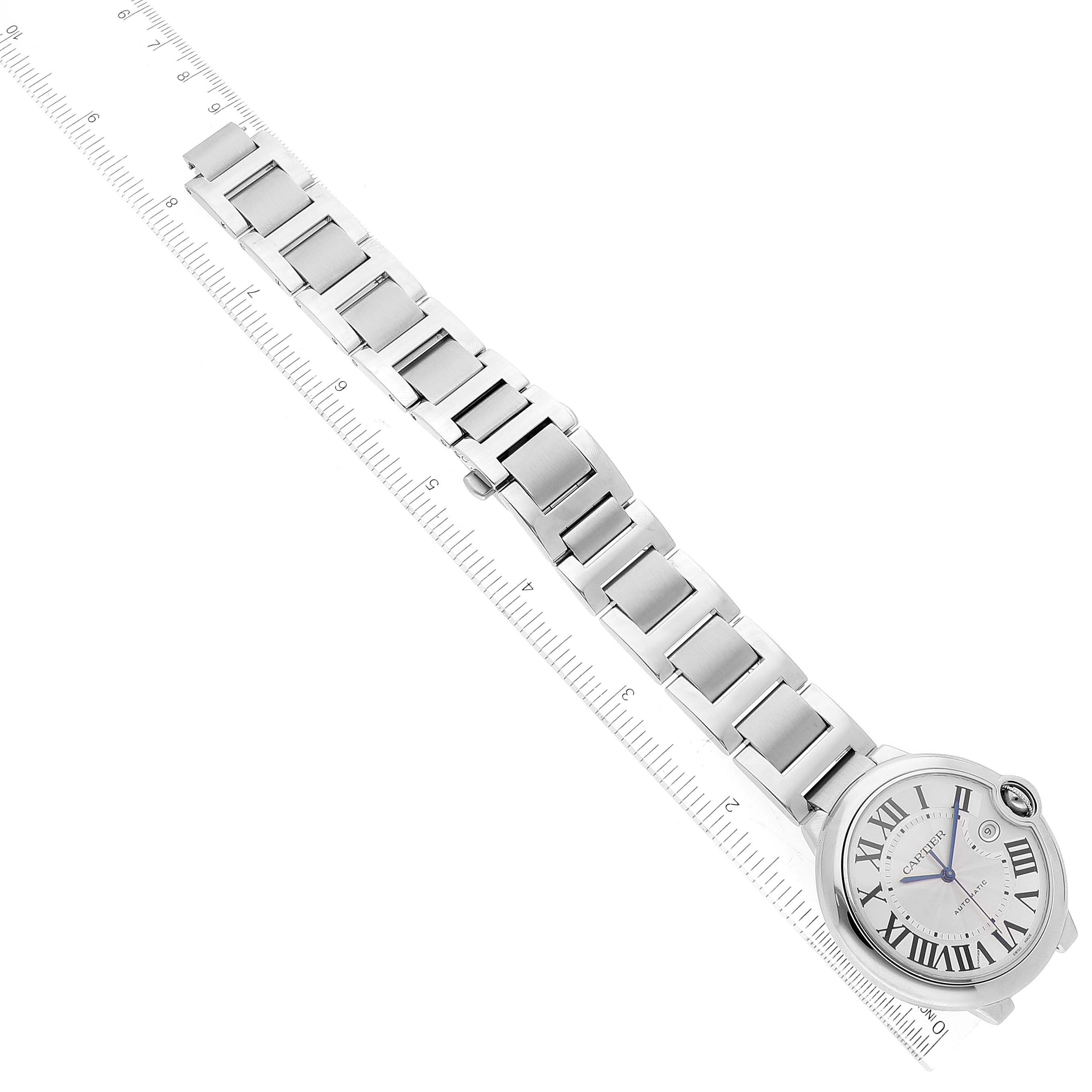 The image shows an overhead view of a Cartier Ballon Bleu W69012Z4 Men's Stainless Steel Silver Dial W69012Z4 Men's Stainless Steel Silver Dial watch, including its face and metal bracelet, placed next to a ruler.